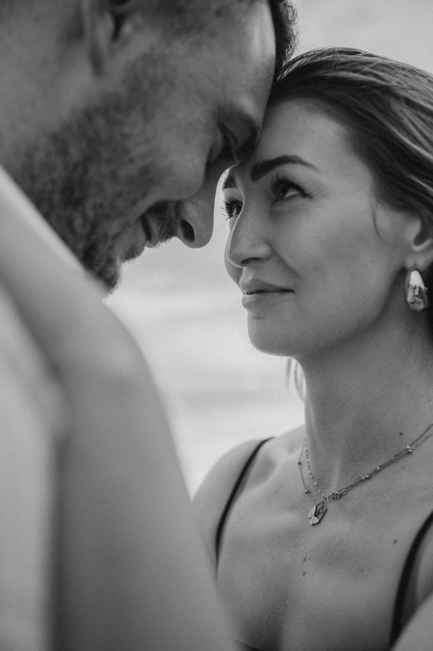 Romantic couple gazing into each other’s eyes and kissing on Playa de La Tejita, Tenerife