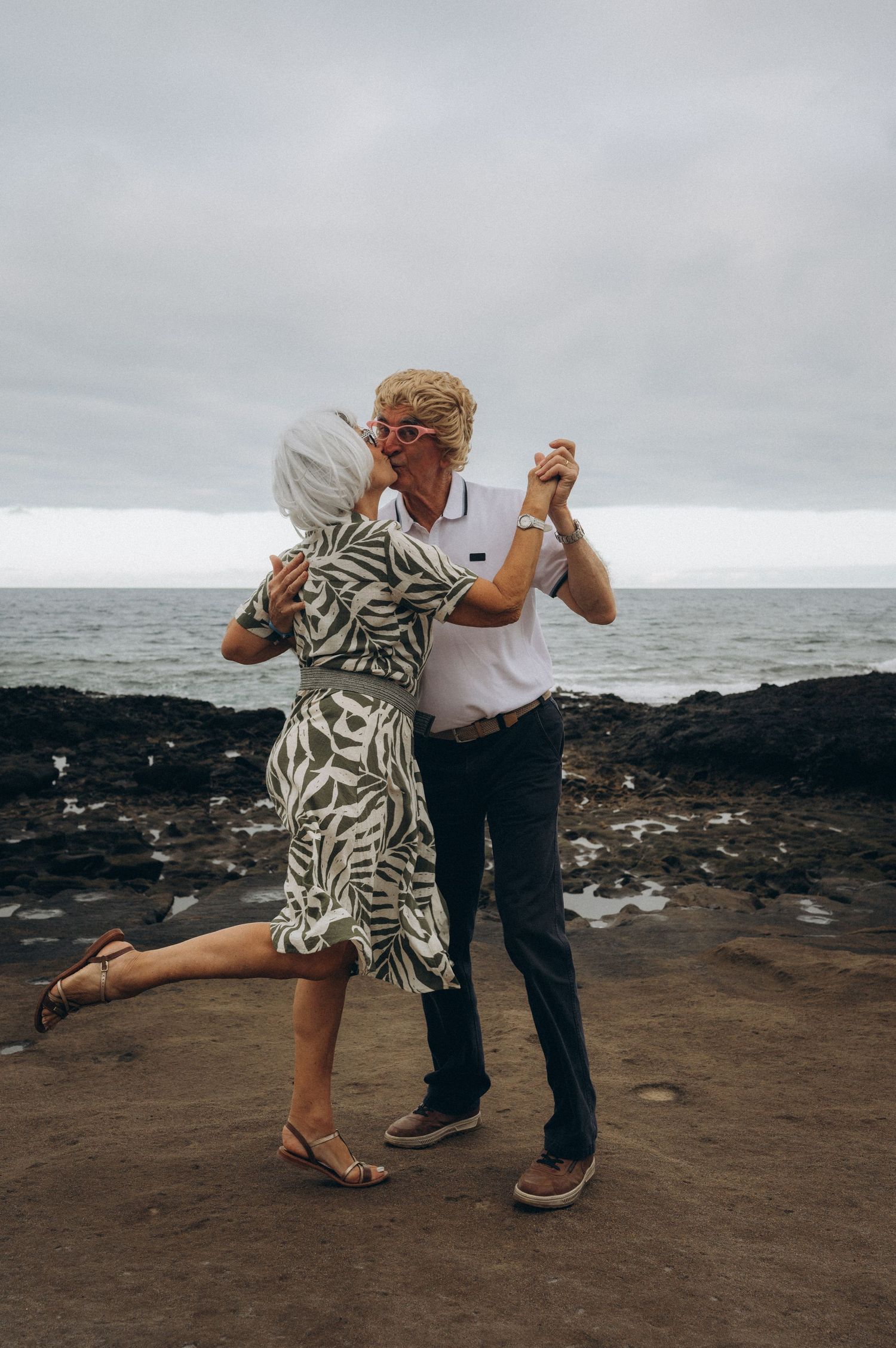 Older couple dancing by the Atlantic Ocean celebrating their wedding anniversary in Tenerife