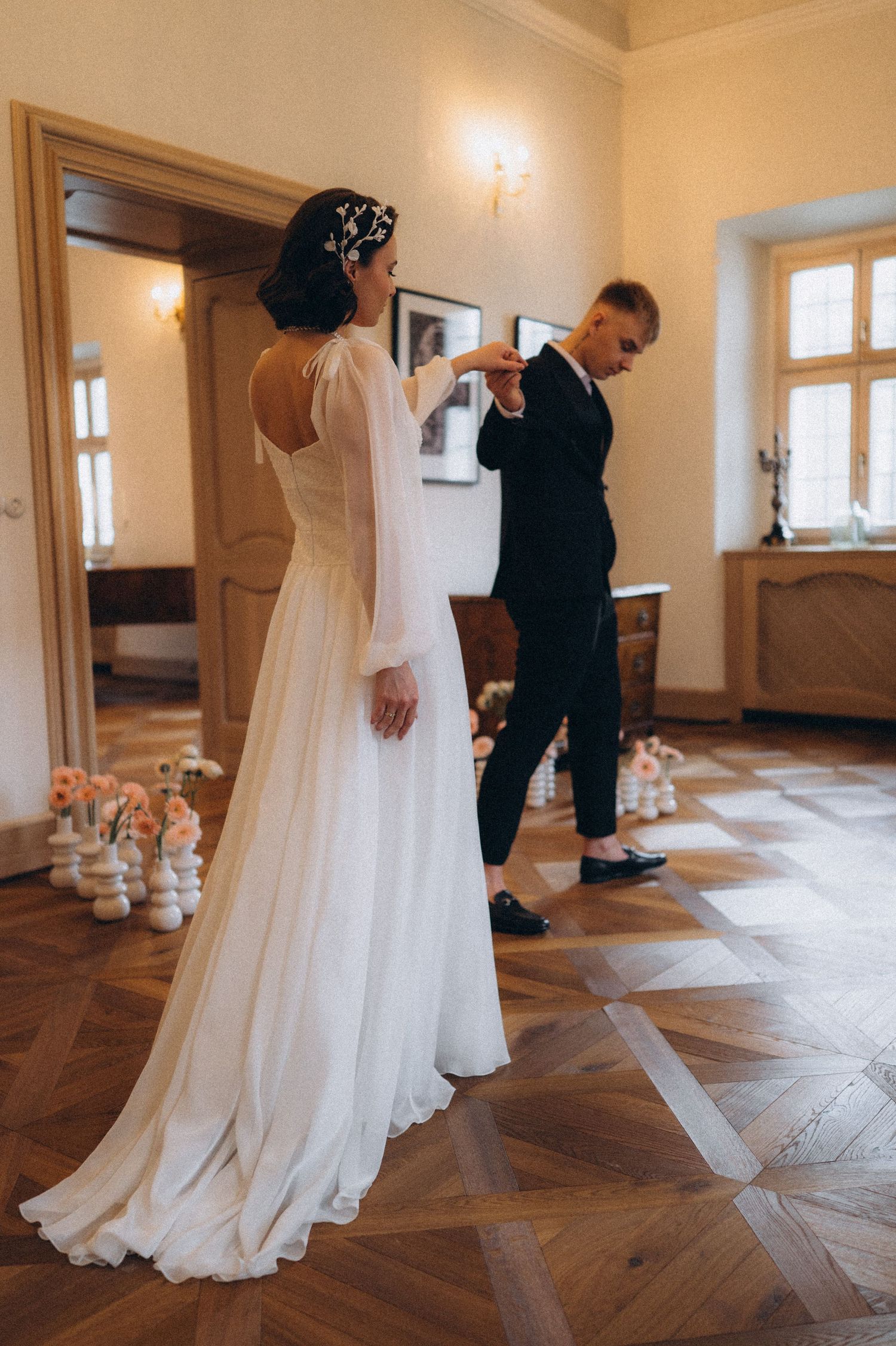 Groom waiting as the bride elegantly walks toward him during their wedding photoshoot.