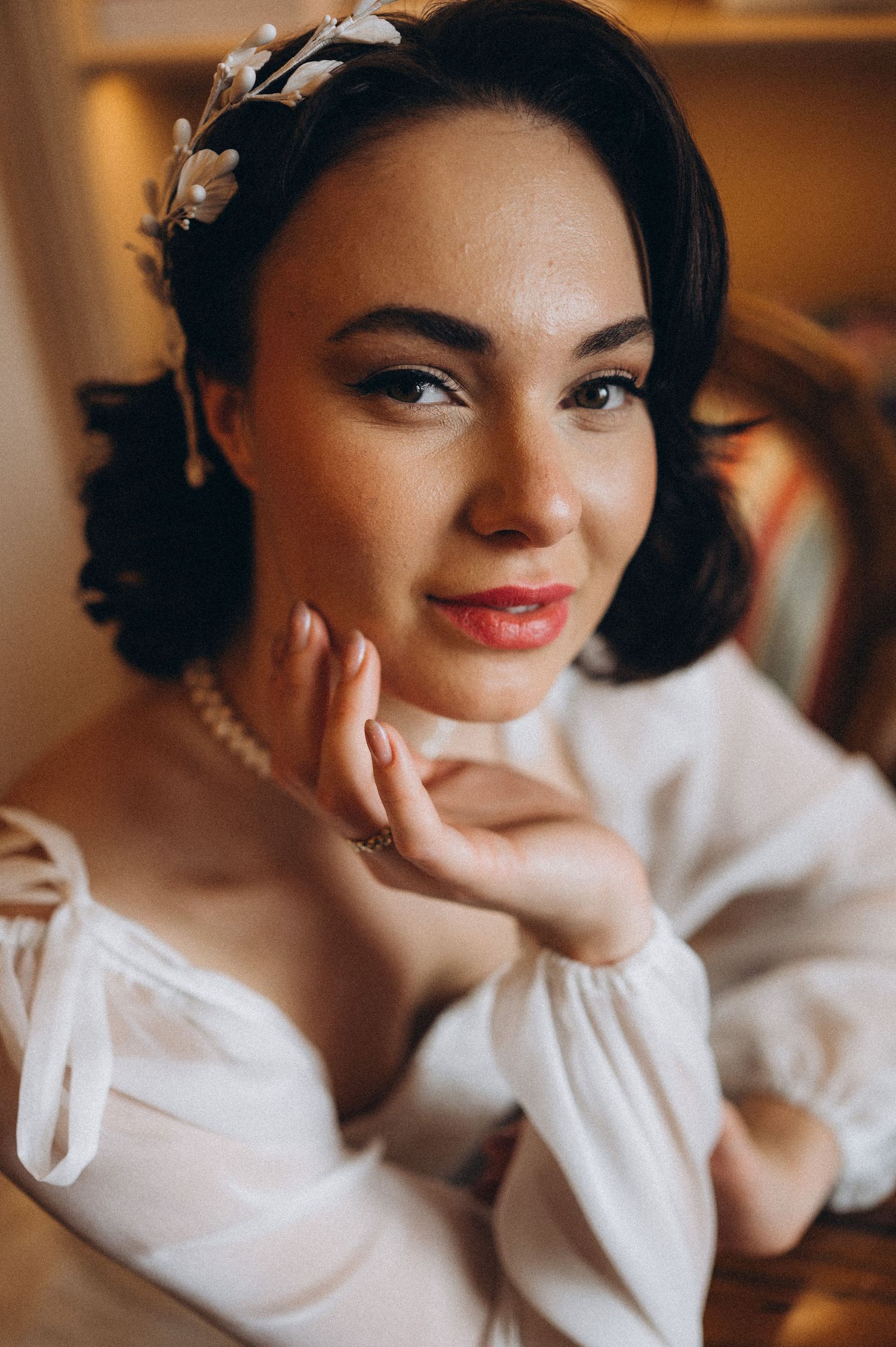 Elegant bridal portrait of the bride posing with her hand gently placed under her chin.
