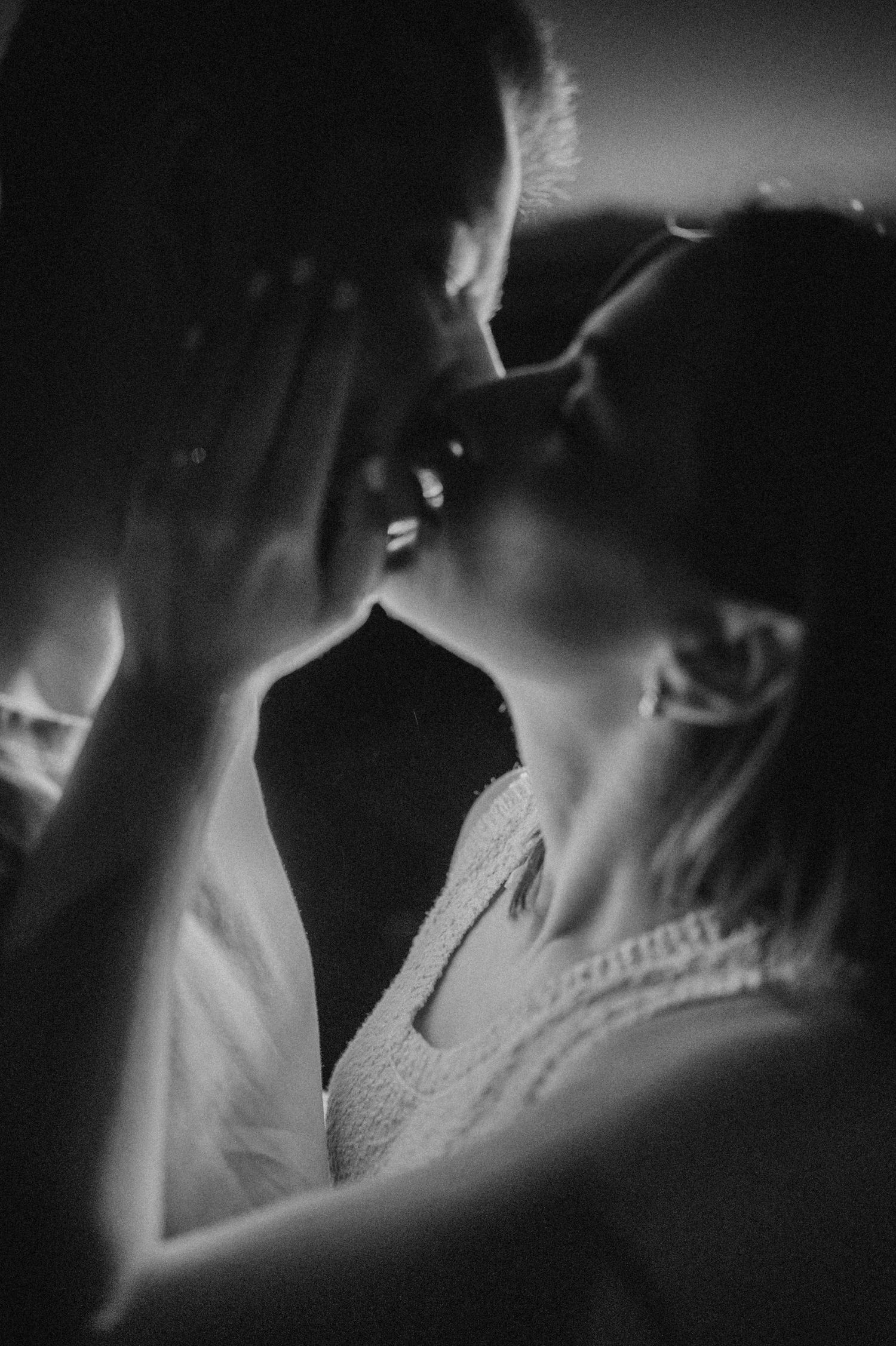 Black and white romantic sequence of intimate couple on Playa de Los Gigantes, Tenerife in low light