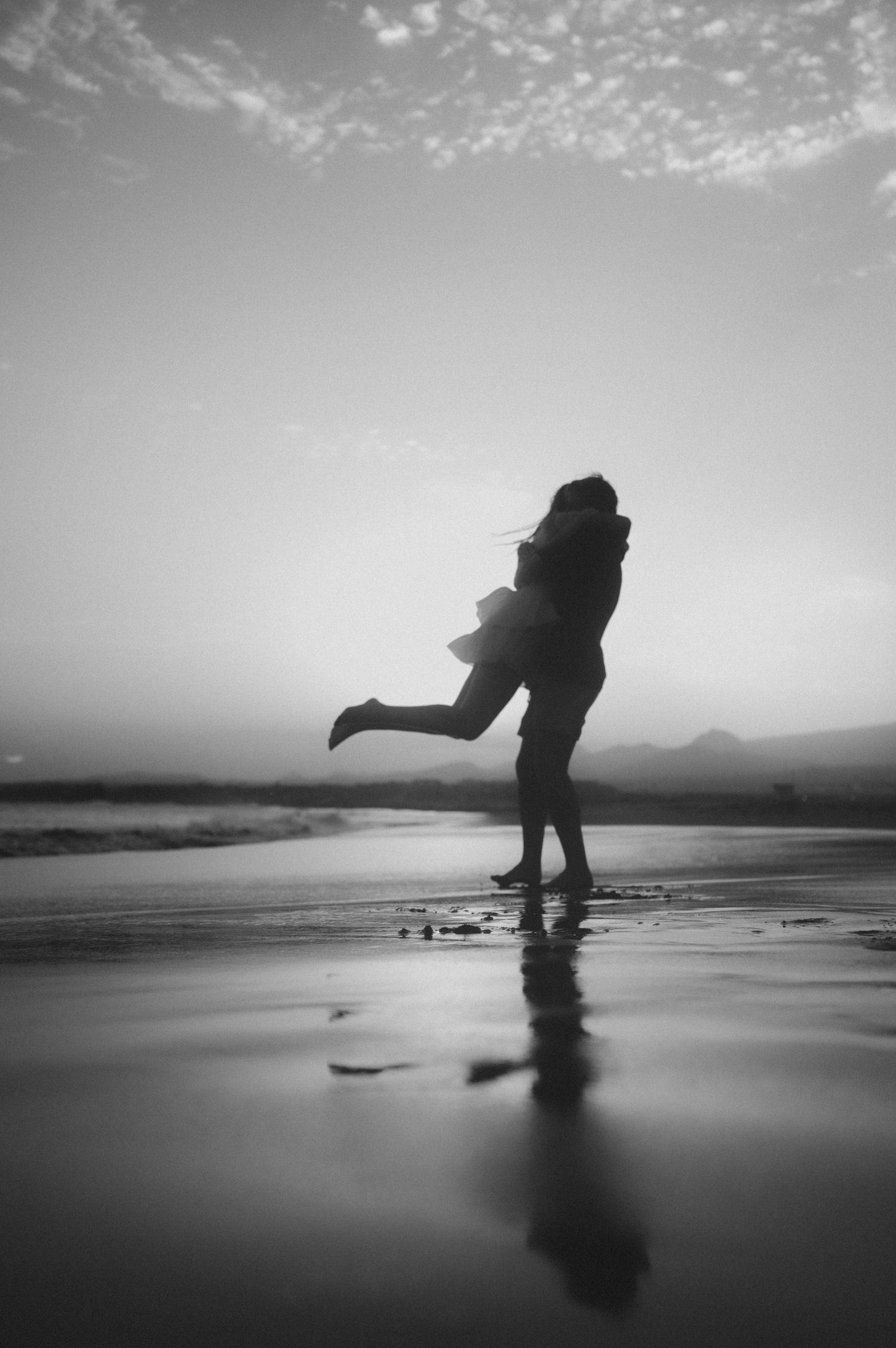 Groom holding his bride in his arms on Playa Tejita, Tenerife wedding photography
