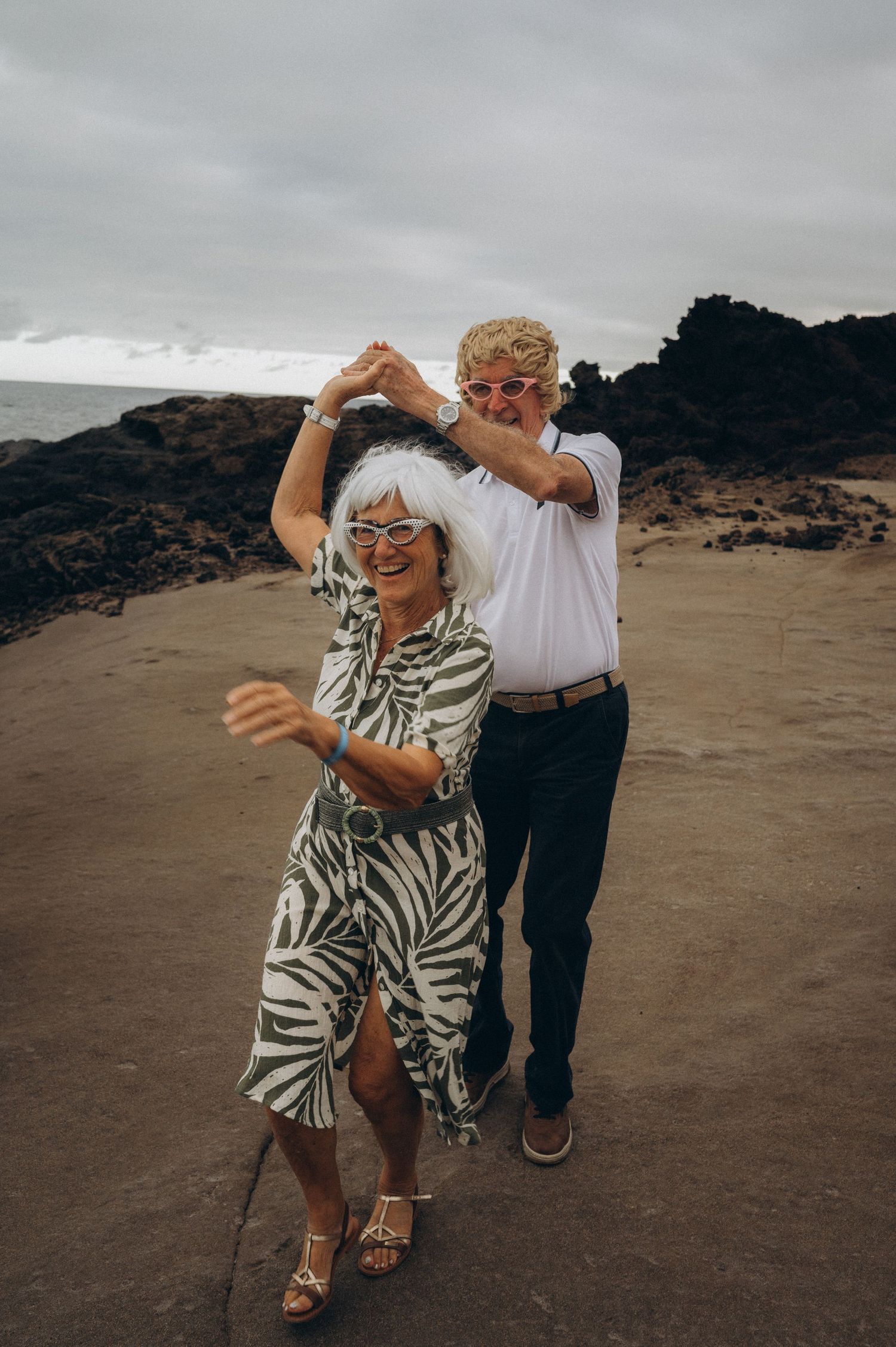 Senior couple enjoying a romantic dance near the ocean on their wedding anniversary, Tenerife