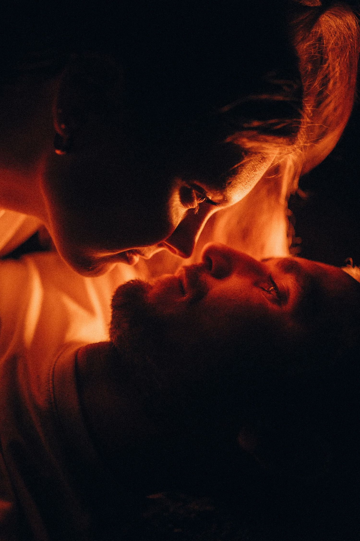 Intimate moment of young couple at sunset in Tenerife, gazing into each other’s eyes