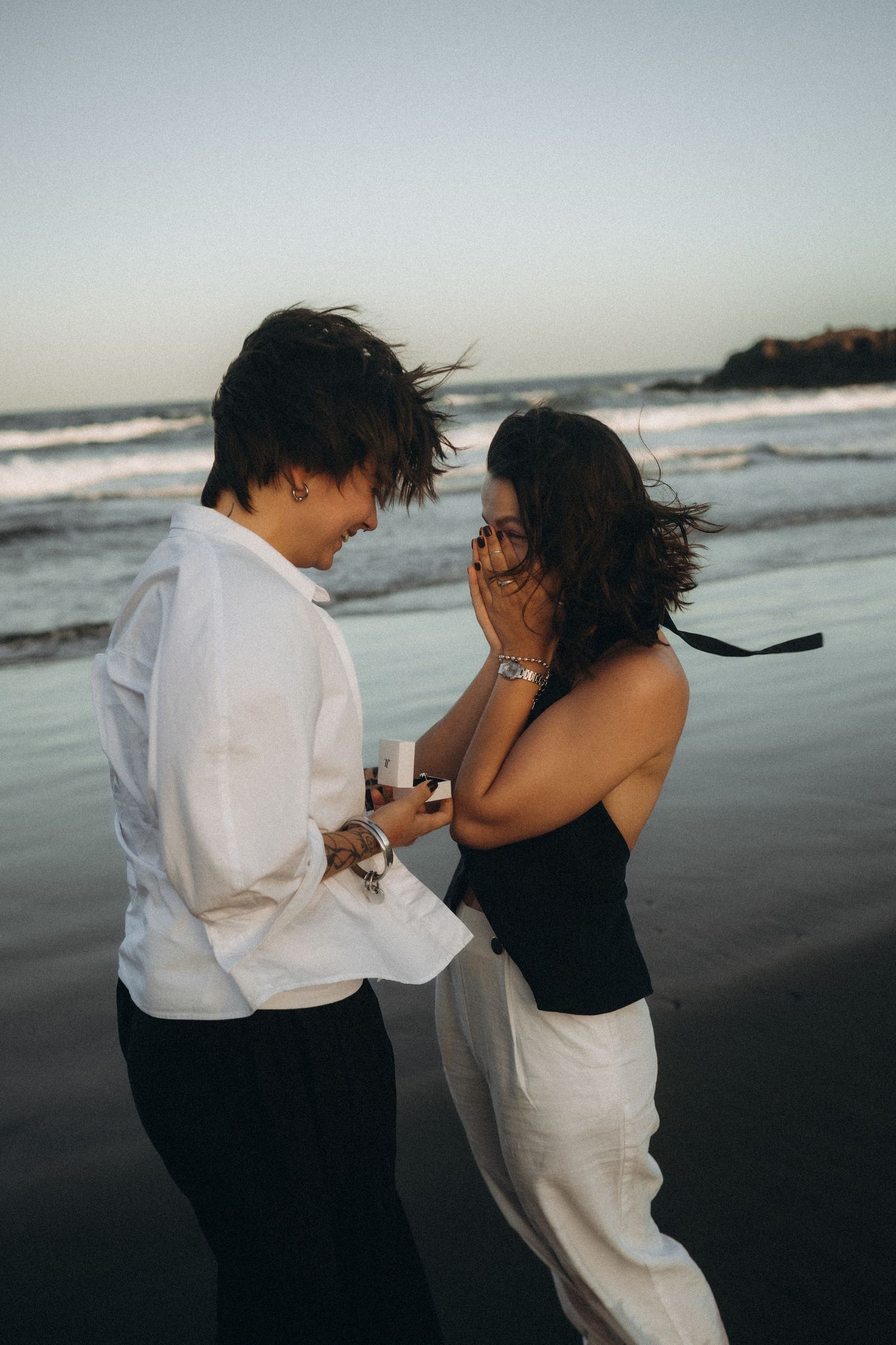 Surprise proposal in Playa Montaña Pelada, Tenerife at dusk on a romantic beach with waves in the background.