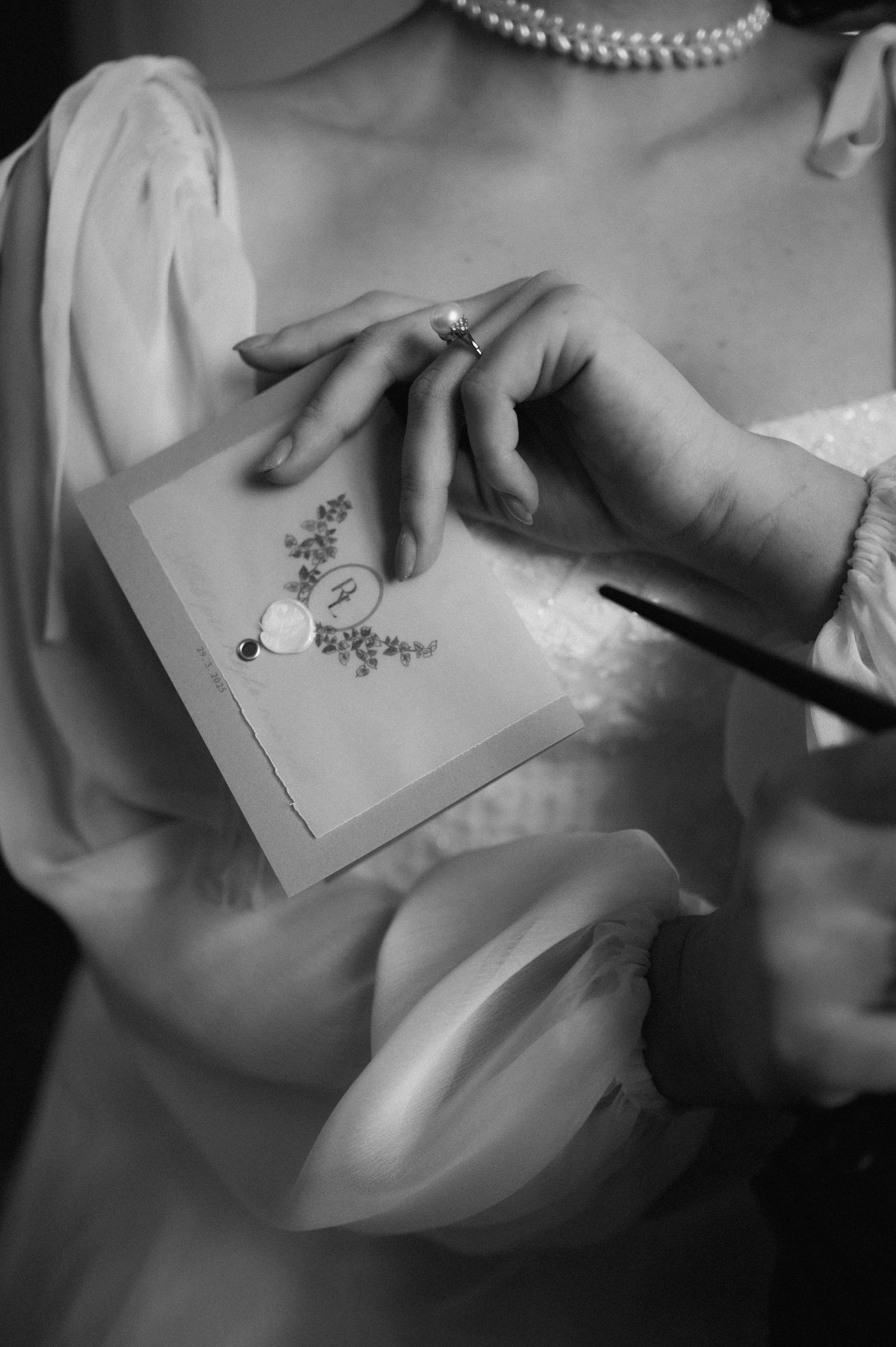 Elegant detail of the bride's hands holding handwritten wedding vows.