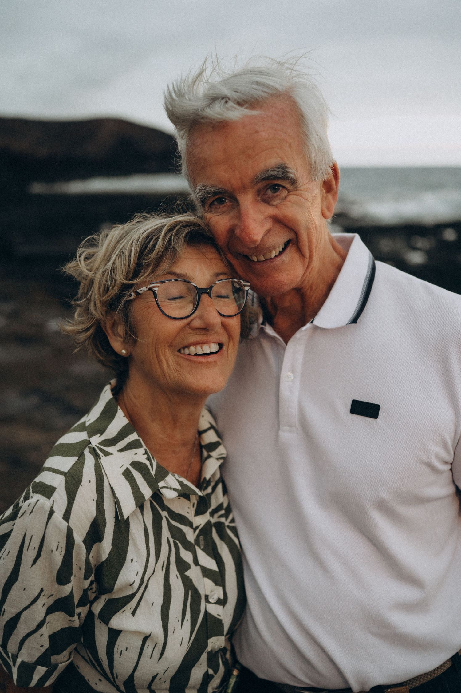 Elderly couple smiling with heads together during photoshoot at Los Refugios, Tenerife