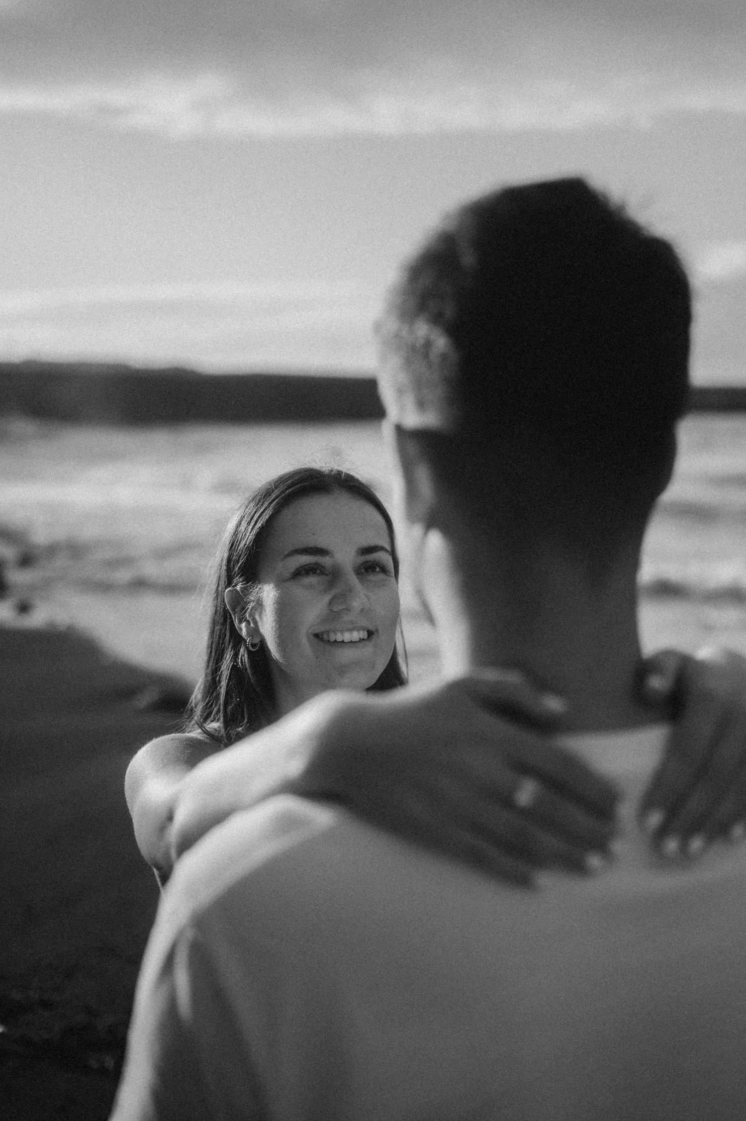 Engagement ring detail on her hand during couple photoshoot at Playa de Los Guíos, Tenerife
