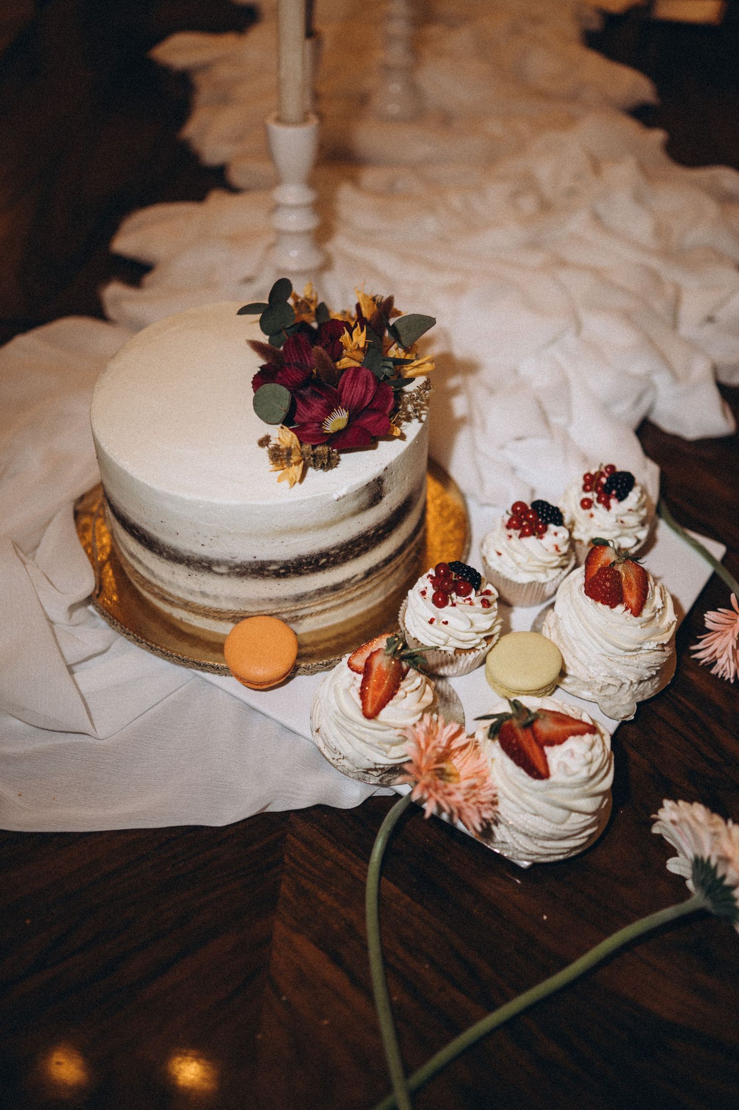 Elegant luxury wedding cake surrounded by refined reception décor and floral styling.