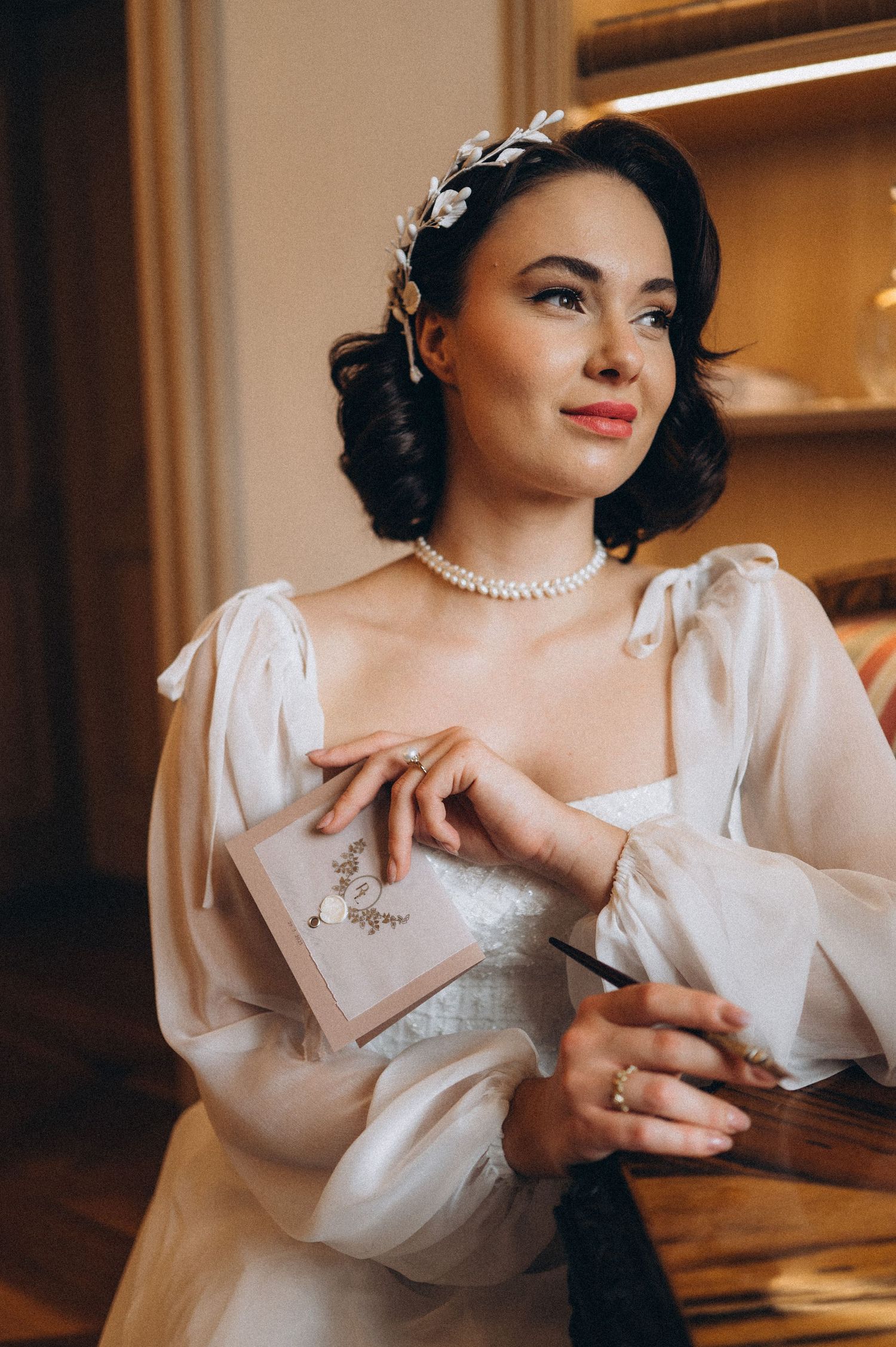 Bride holding her wedding vows during a quiet bridal preparation moment.