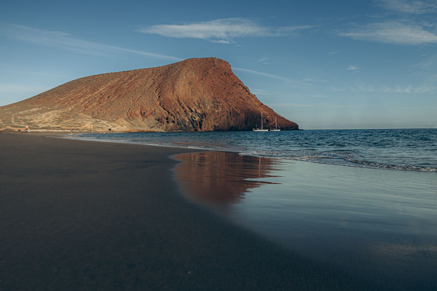 Distant view of entire Playa La Tejita with Atlantic Ocean and majestic Montaña Roja in background, Tenerife