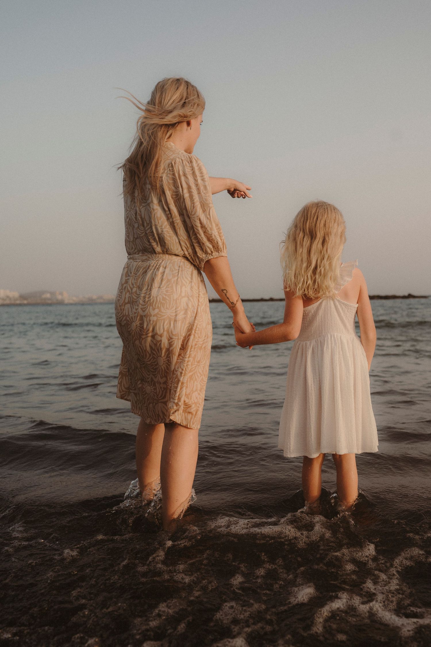 Mother and daughter holding hands admiring Atlantic Ocean, Tenerife