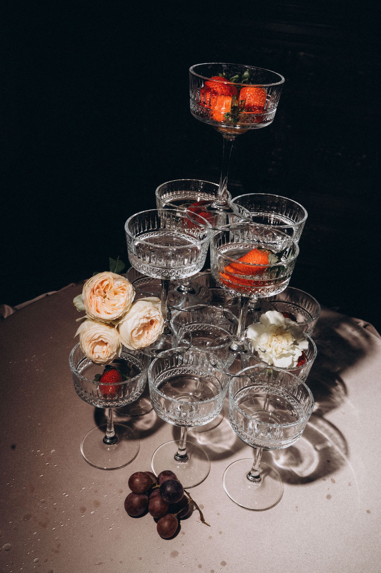 Elegant champagne glasses served with fresh strawberries as a luxurious wedding reception detail.