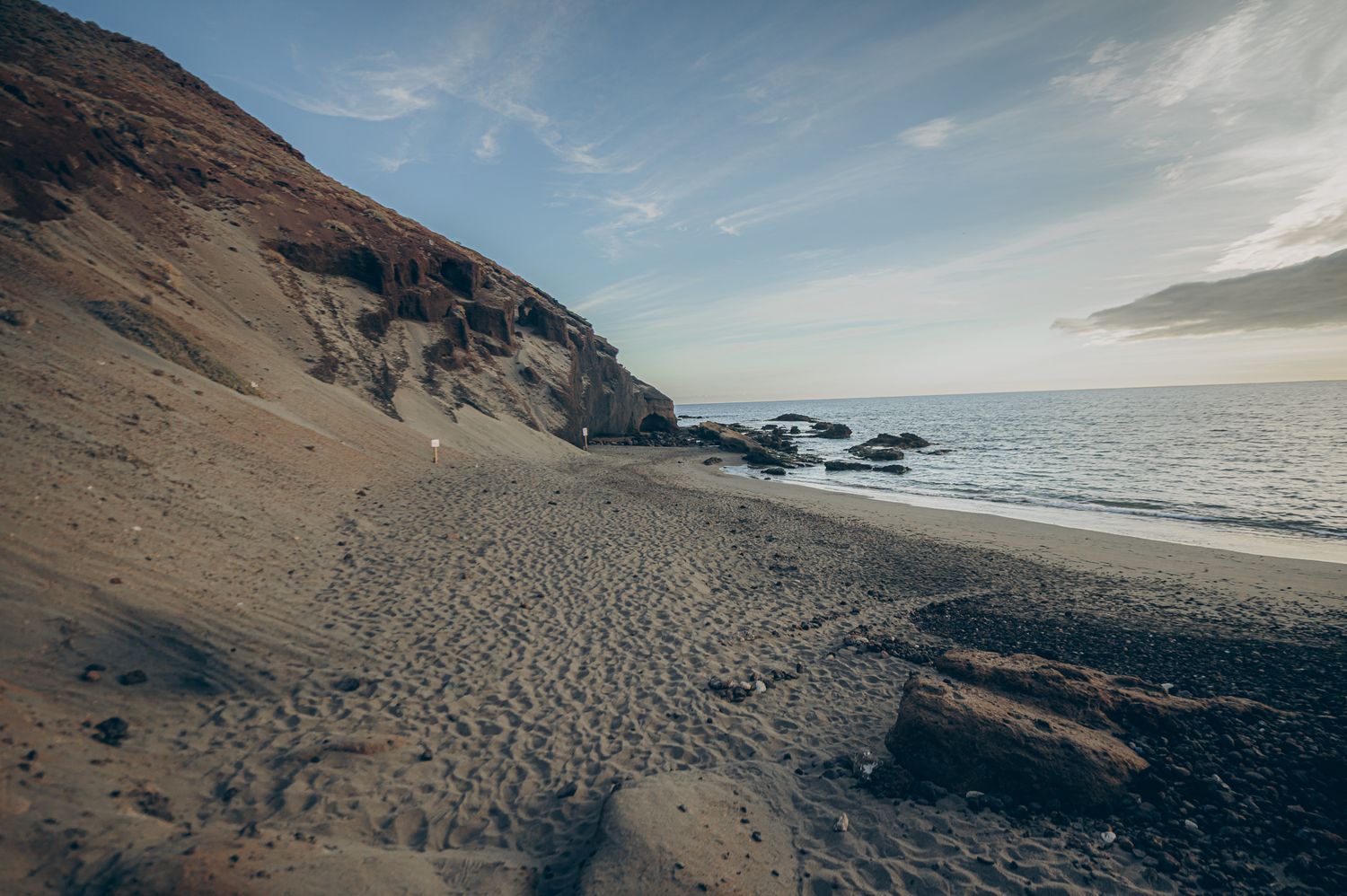 Black sand beach at Montaña Roja near Playa La Tejita with volcanic landscape, Tenerife