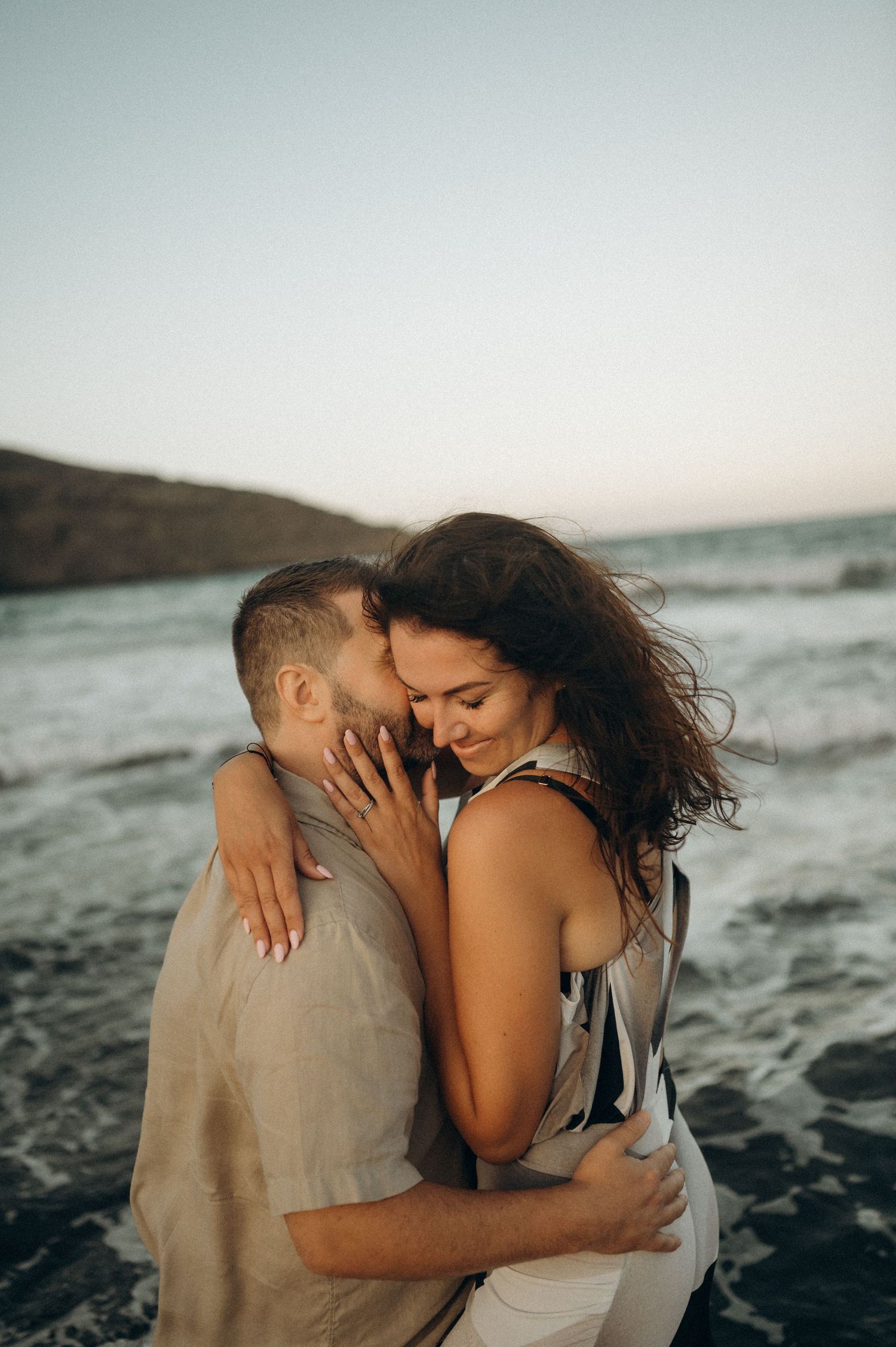 Loving couple embracing on Playa Montaña de Pelada beach in Tenerife.