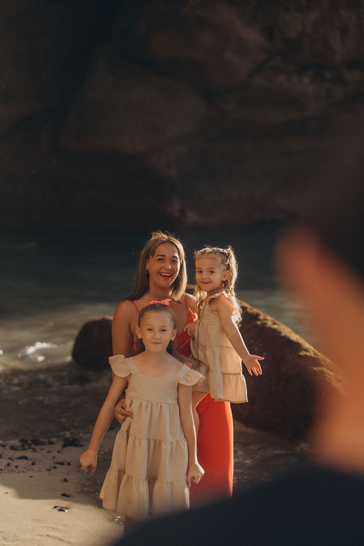 Shot from behind father with his wife and daughters smiling at him during family photoshoot