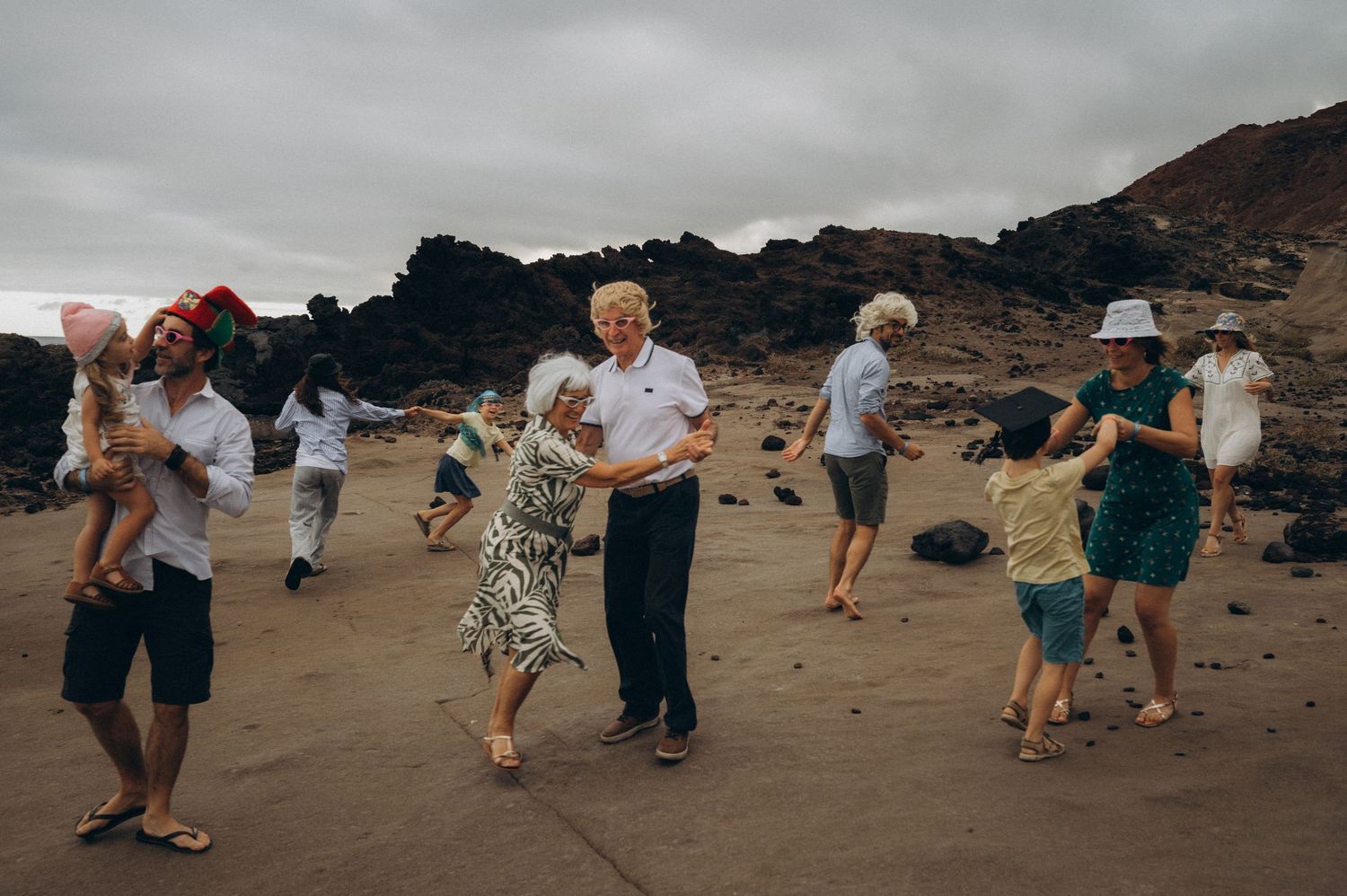 Couples in the family putting on wigs and dancing during a fun tradition at Los Refugios, Tenerife