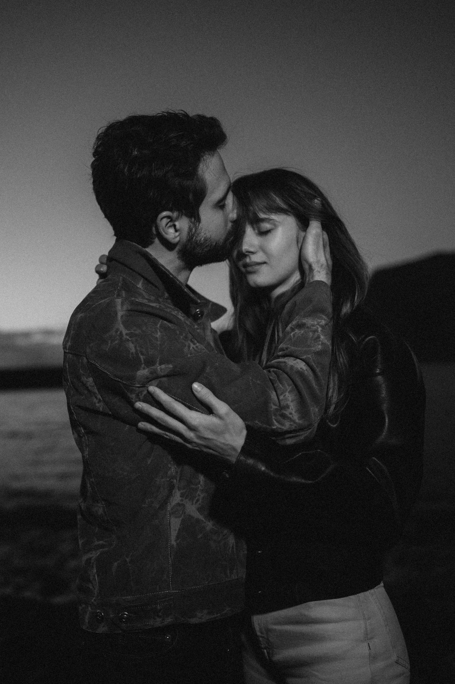 Romantic couple standing forehead to forehead in evening light, Los Gigantes, Tenerife