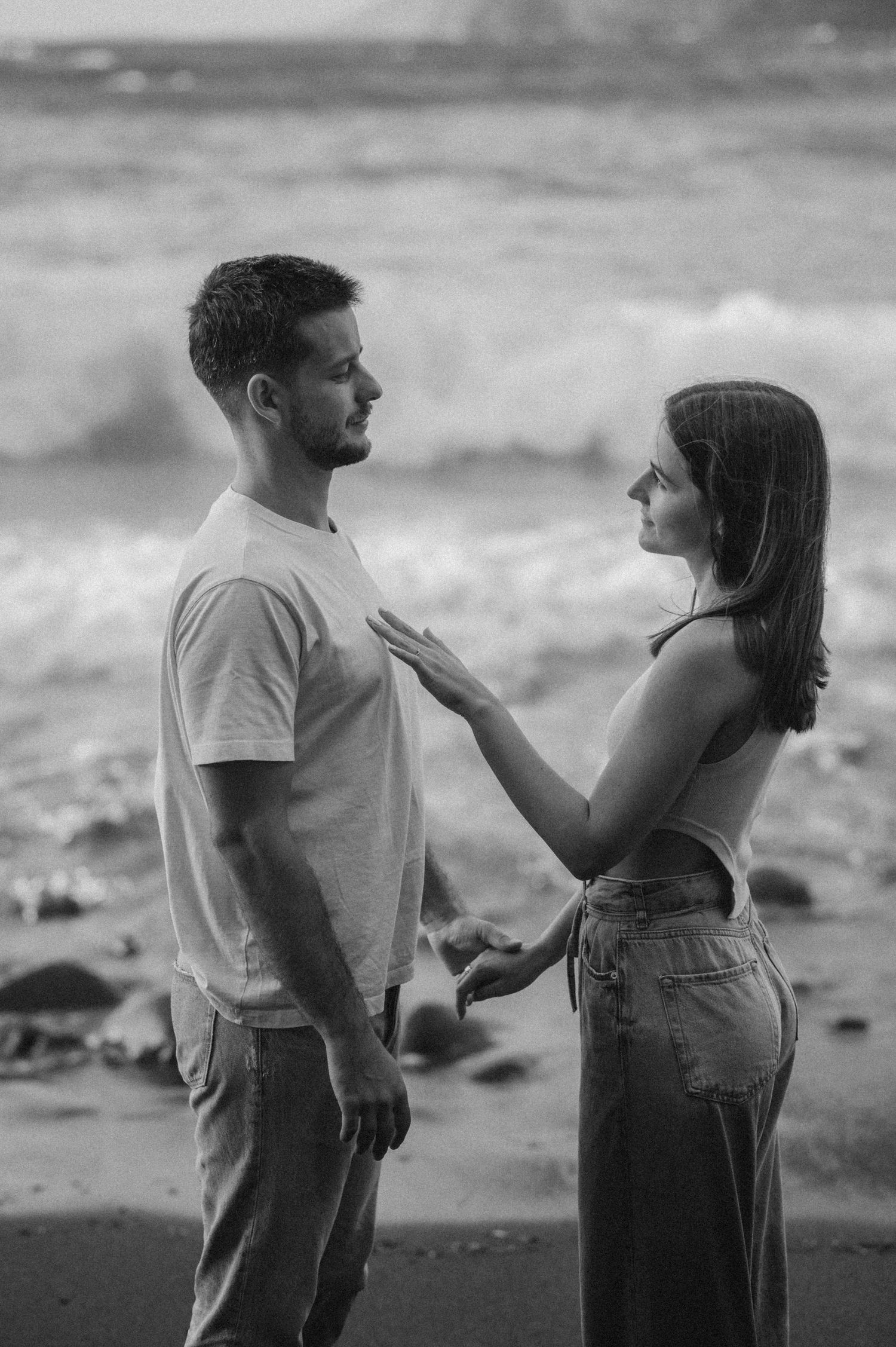 Black and white photo sequence of couple having emotional conversation on Playa de Los Guíos beach in Los Gigantes, Tenerife