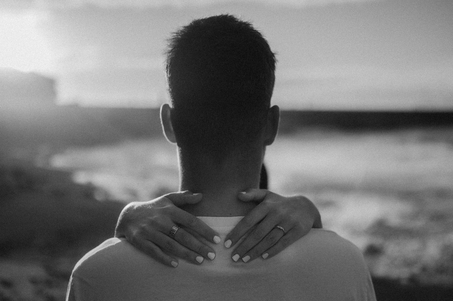 Close-up of woman’s hand with engagement ring at Playa de Los Guíos, Tenerife cliffs