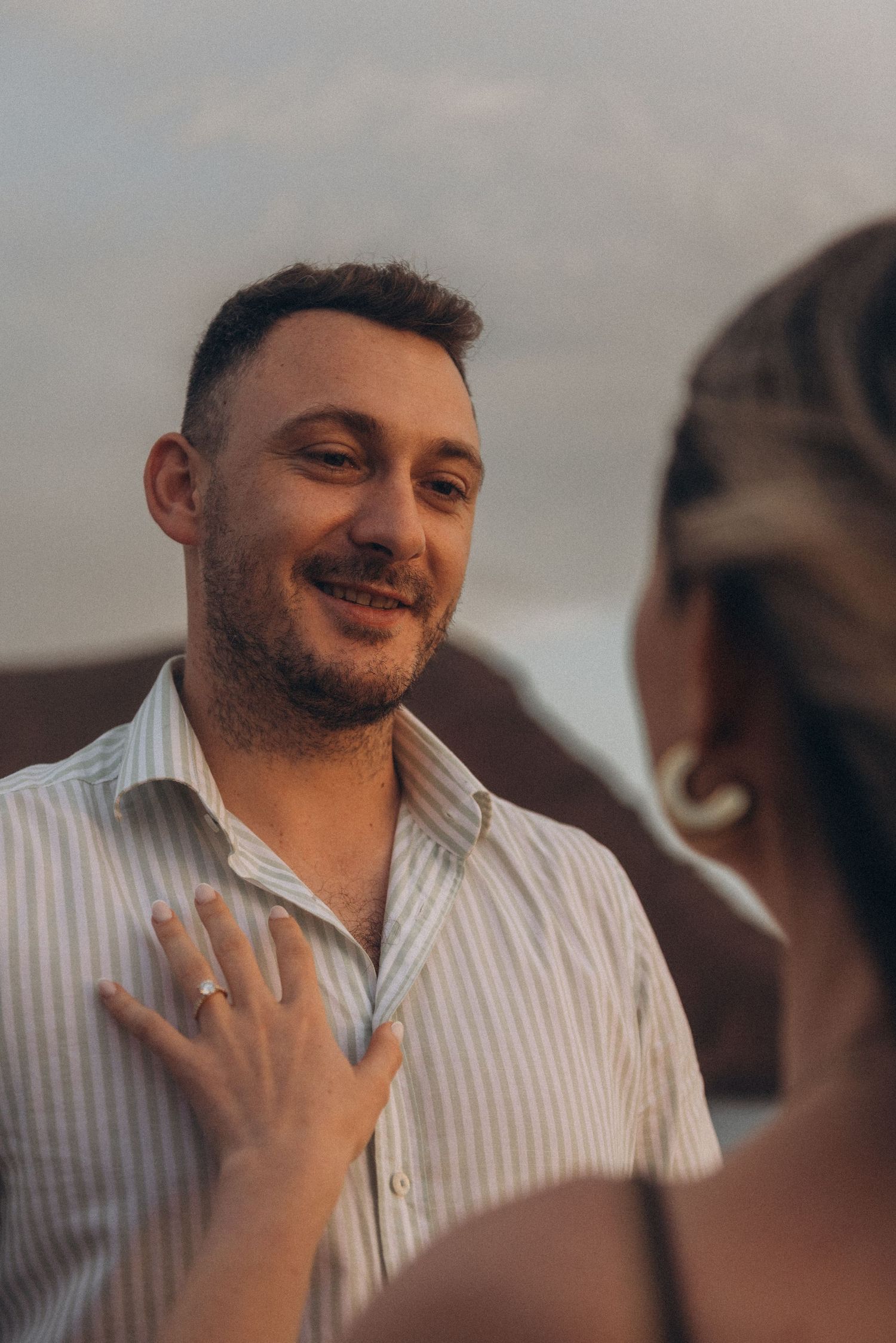 Romantic couple looking at each other during sunset on Playa de La Tejita, Tenerife
