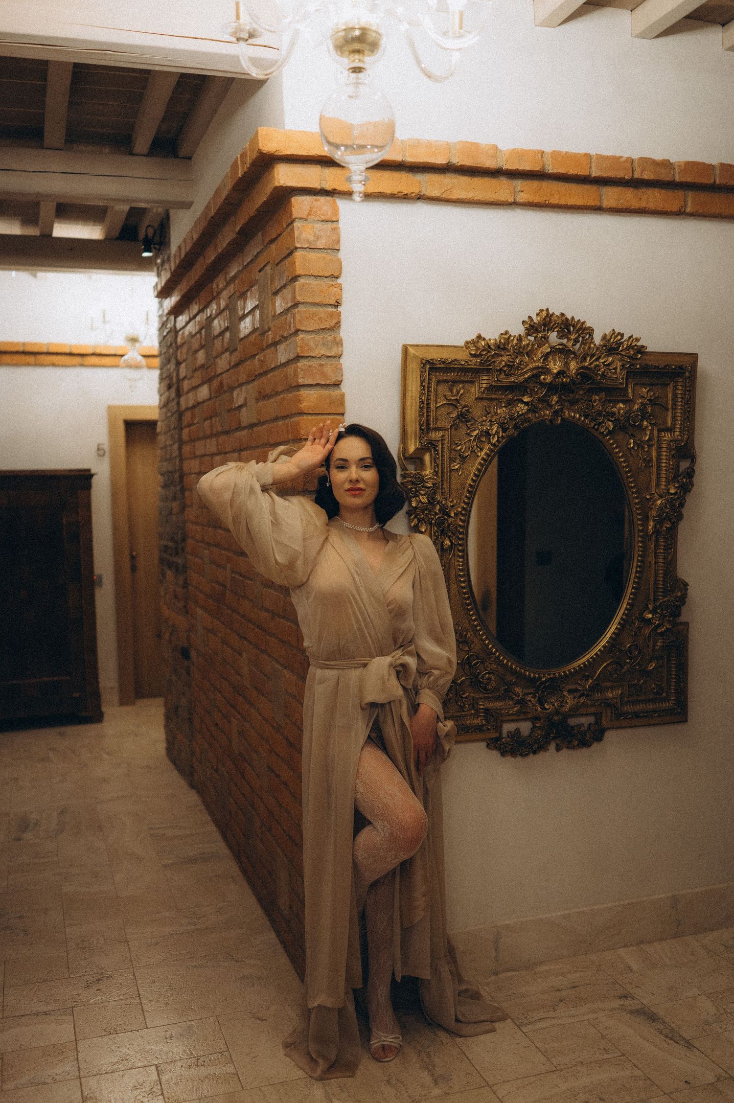 Elegant bridal portrait of the bride posing in a vintage-style interior.