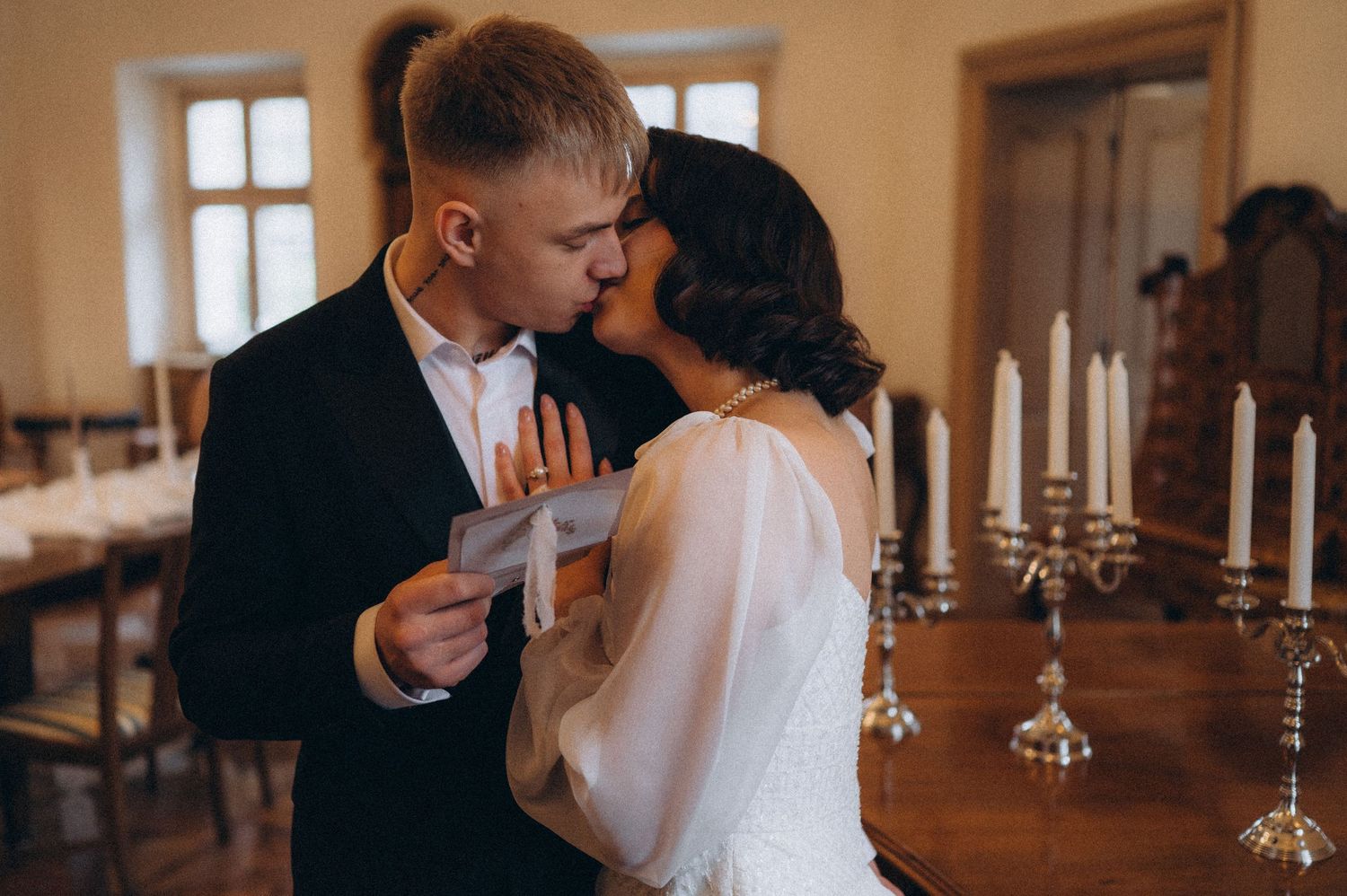 Romantic couple moment with the bride leaning into the groom’s neck and his hand gently caressing her.