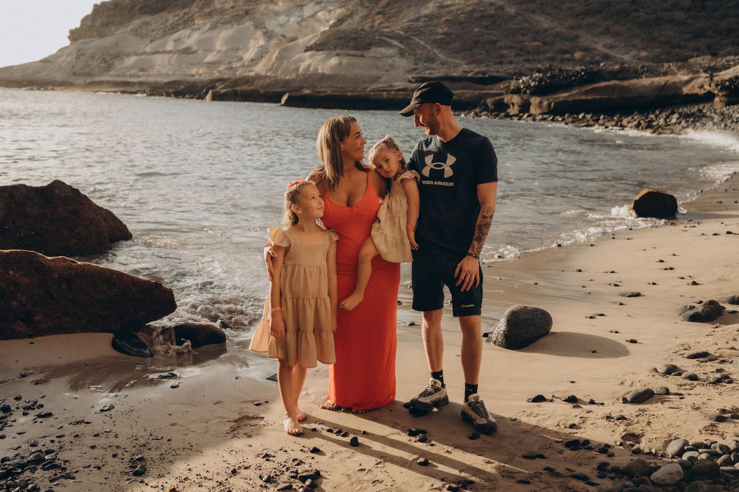Parents and children looking at each other and smiling on Playa de los Morteros beach