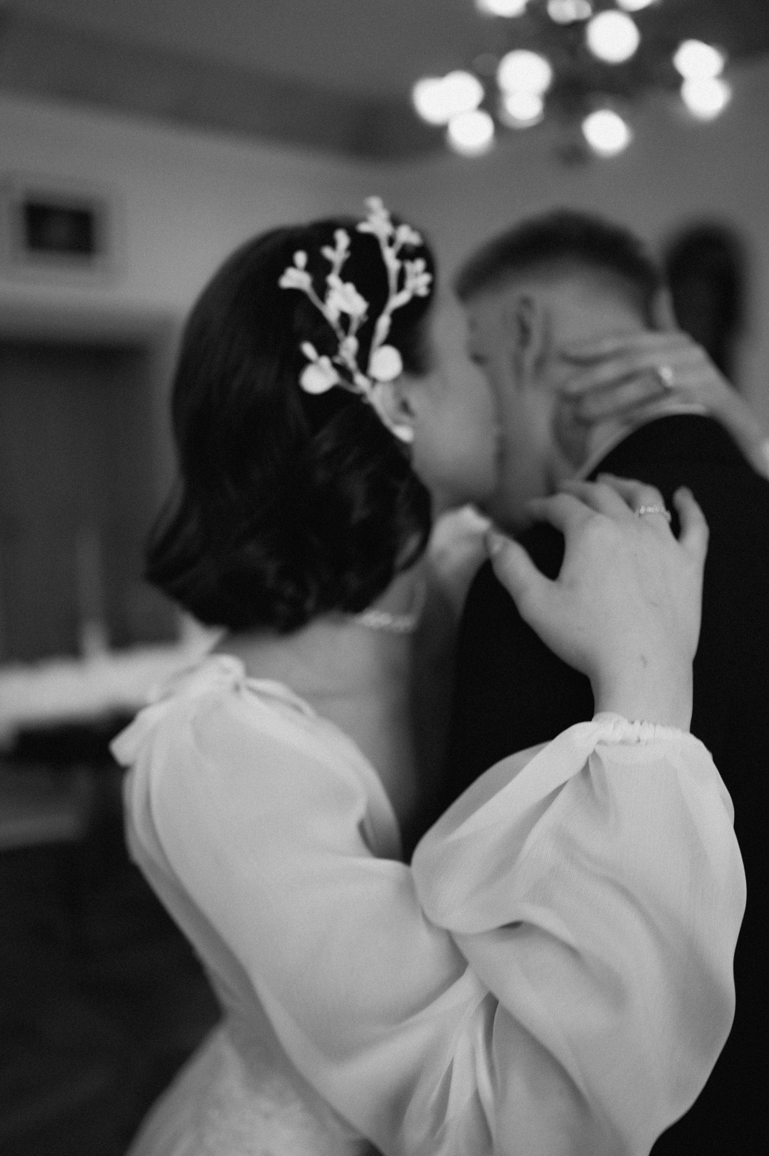 Intimate wedding portrait of a bride and groom sharing a quiet embrace with the bride resting on his shoulder.