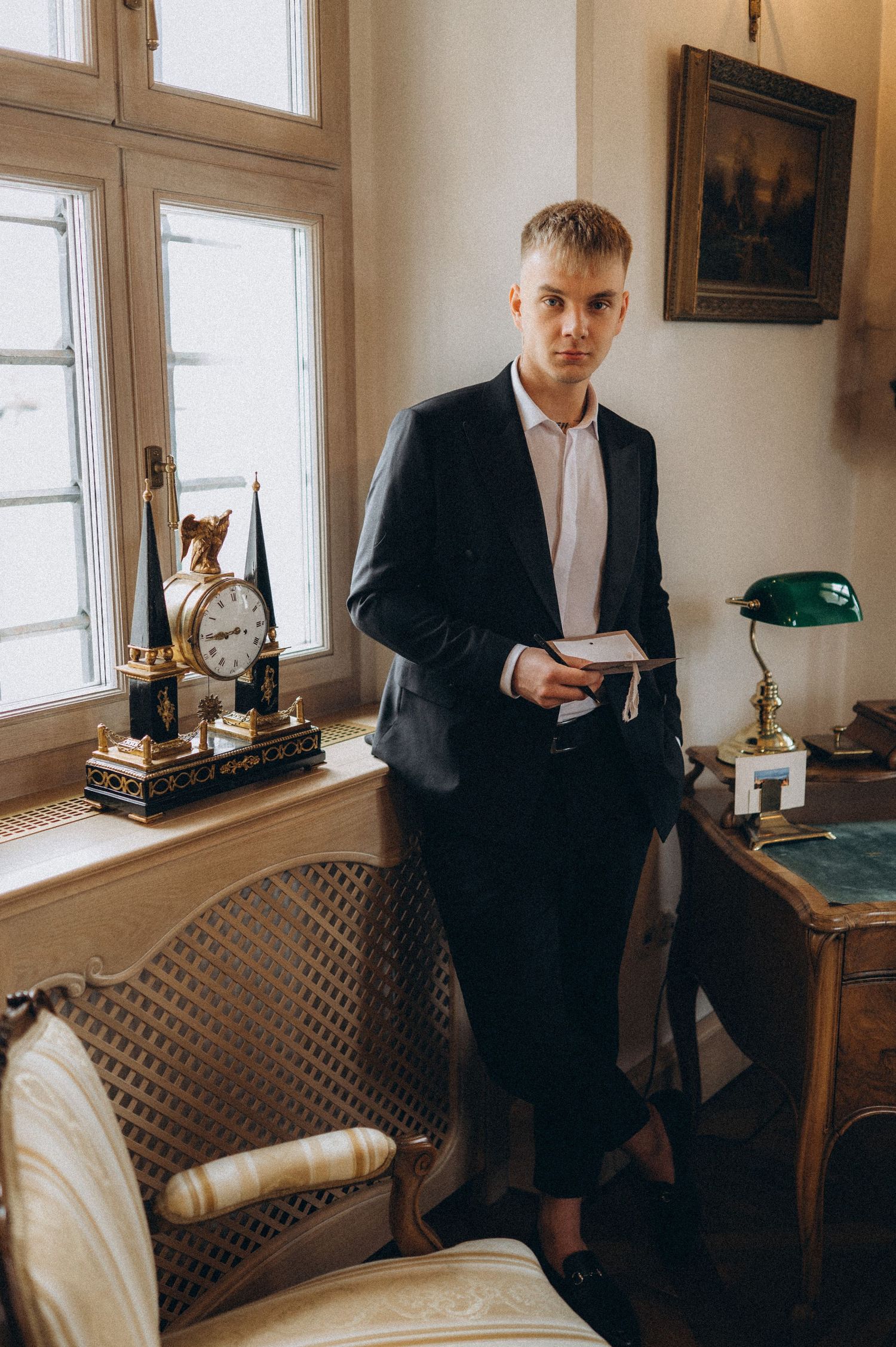 Groom captured leaving the table with his handwritten vows during a quiet wedding moment.