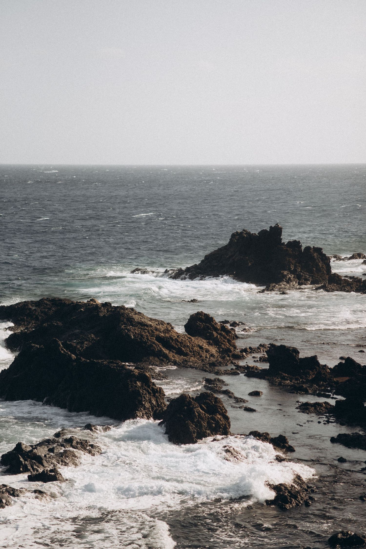 Rocky coastline with waves crashing against cliffs, Tenerife