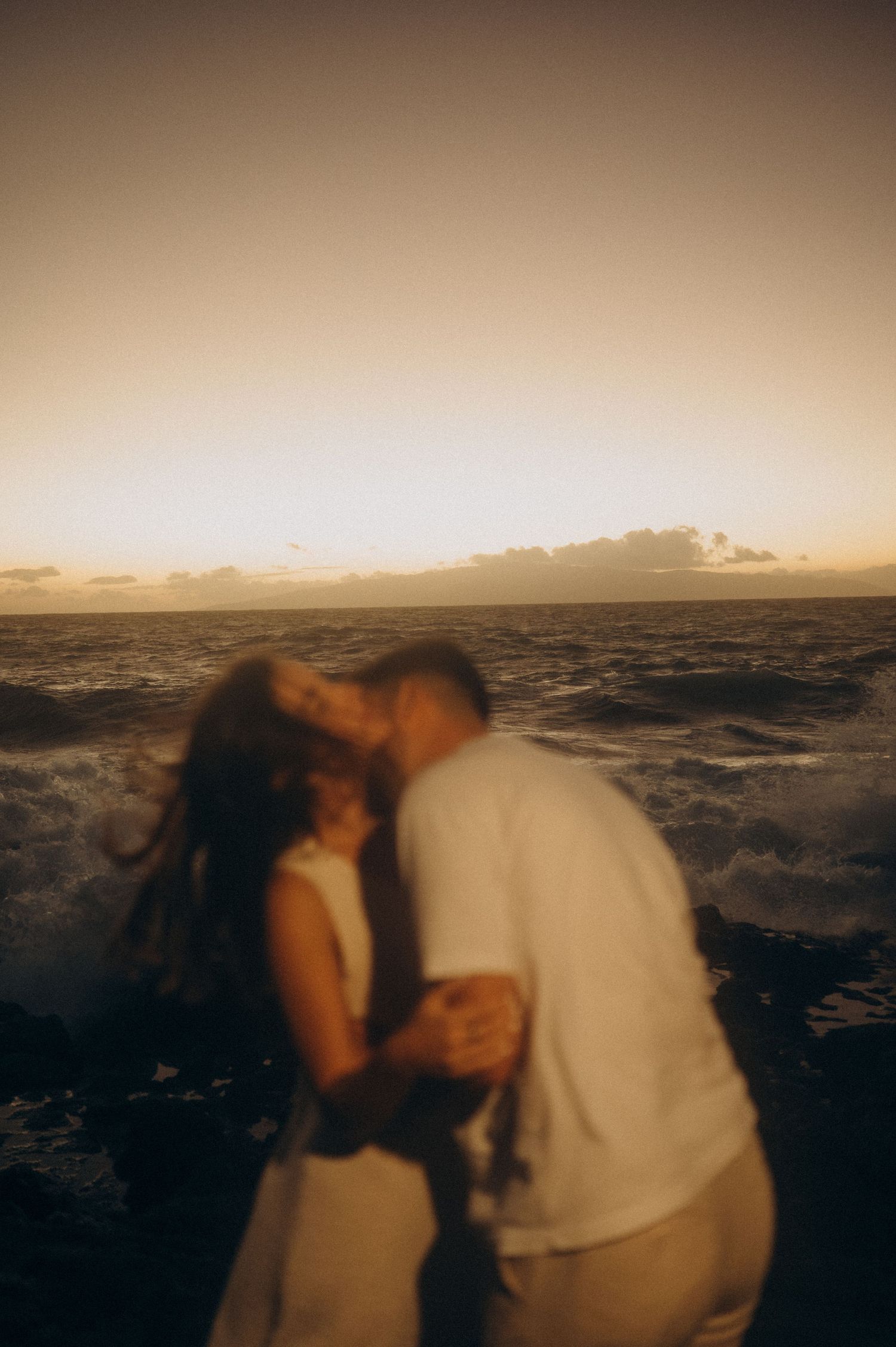 Couple enjoying intimate connection, gazing at each other under lights on south Tenerife beach