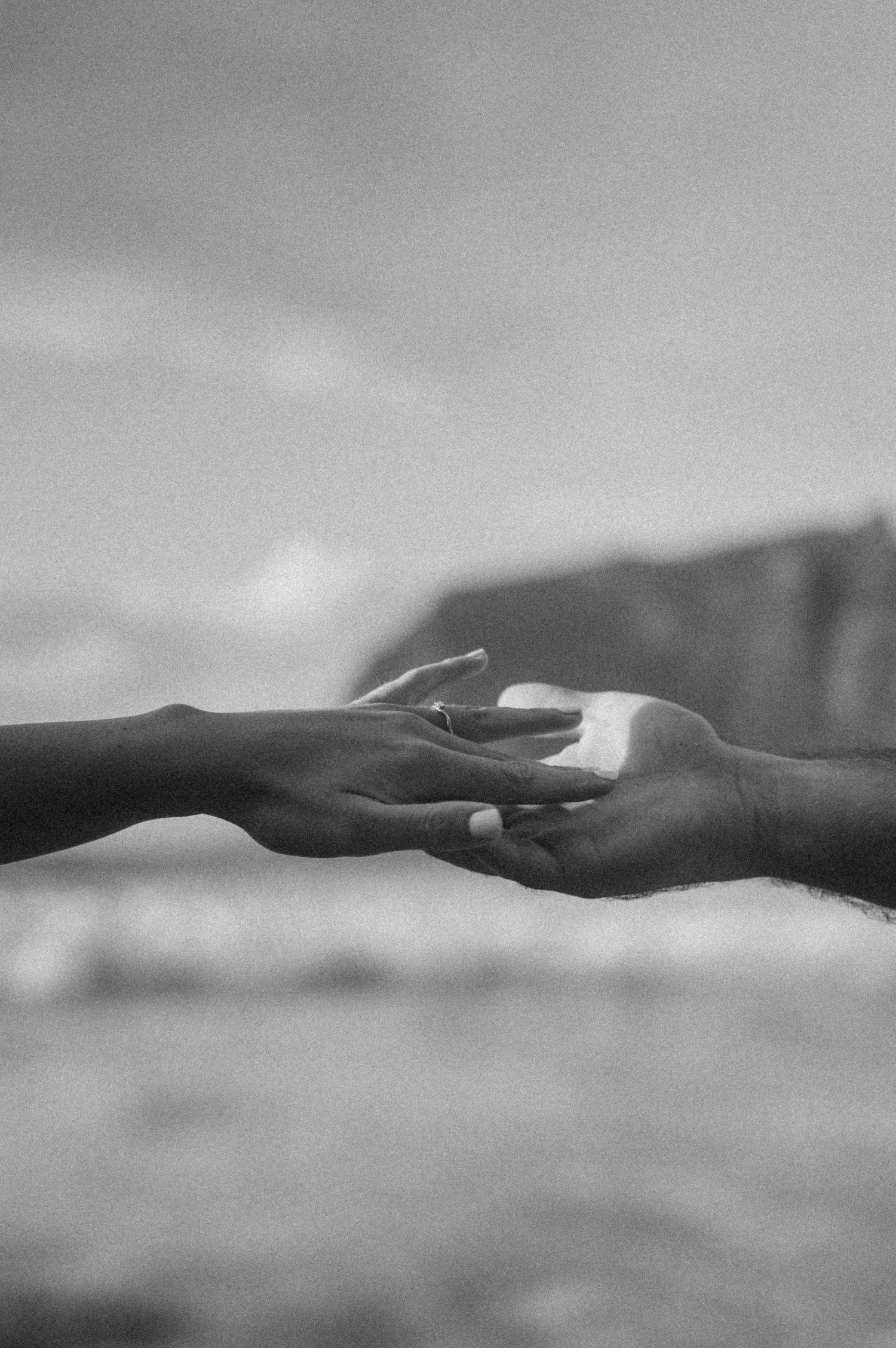 Intimate close-up of newly engaged couple’s hands on Playa de Los Guíos, Tenerife