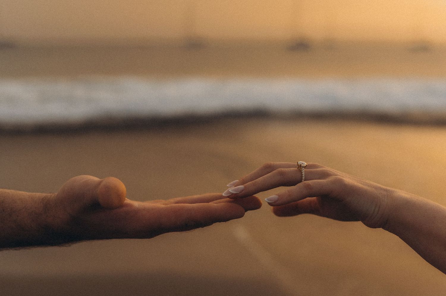 Young couple sharing intimate gaze with sunset over Playa de La Tejita, Tenerife