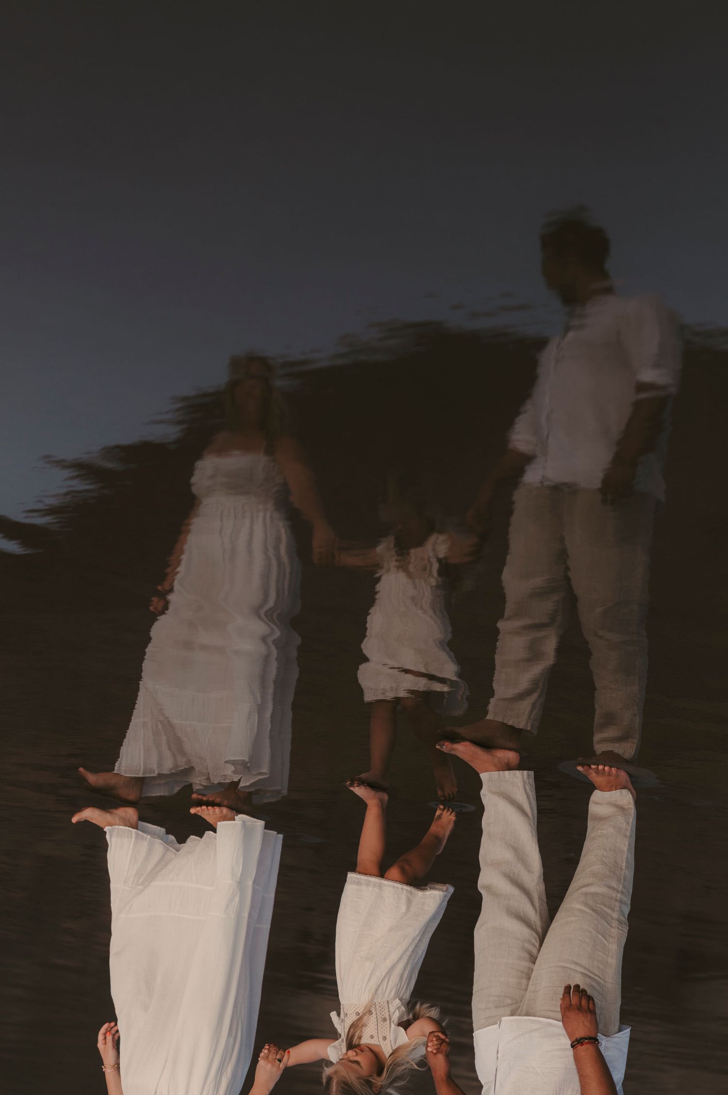 Artistic reflection of a family in the sand at Playa La Tejita, storytelling family photography