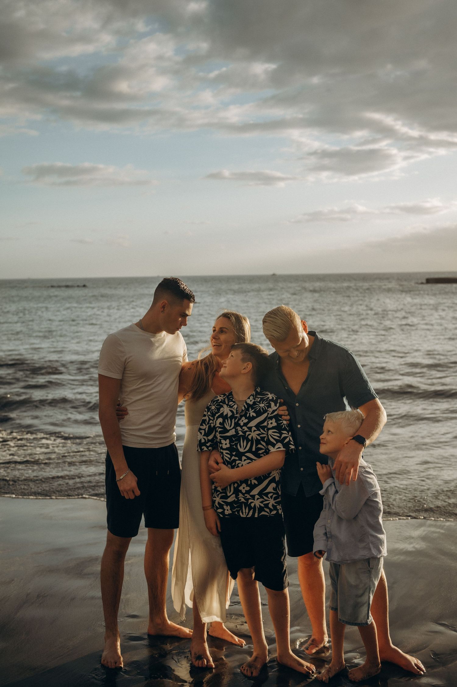 Classic family portrait by the sea with everyone gazing at each other, Playa Fañabé