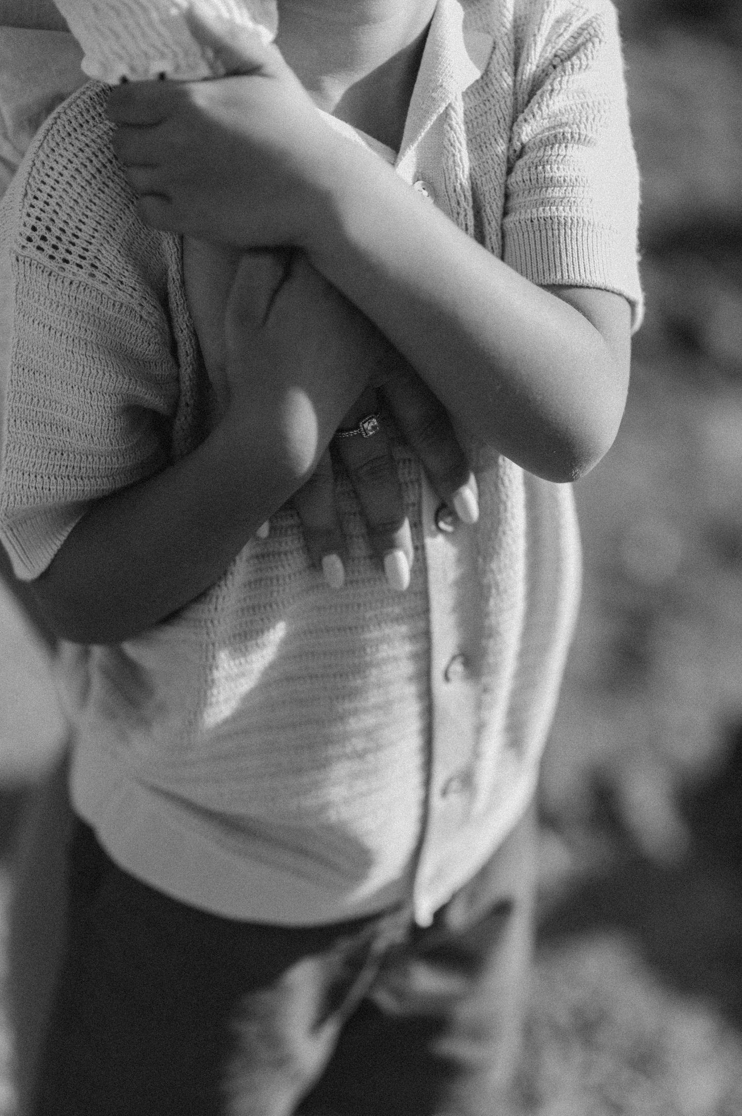 Intimate close-up of child holding mother’s hand near neck, Playa Montaña Pelada