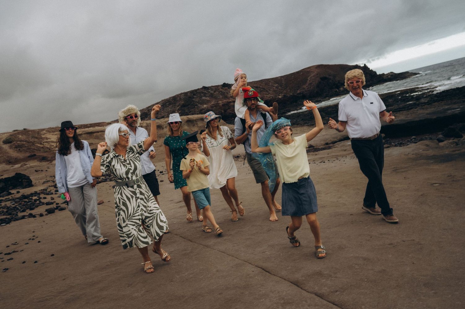 Family enjoying a playful dance with wigs at Los Refugios, Tenerife photoshoot