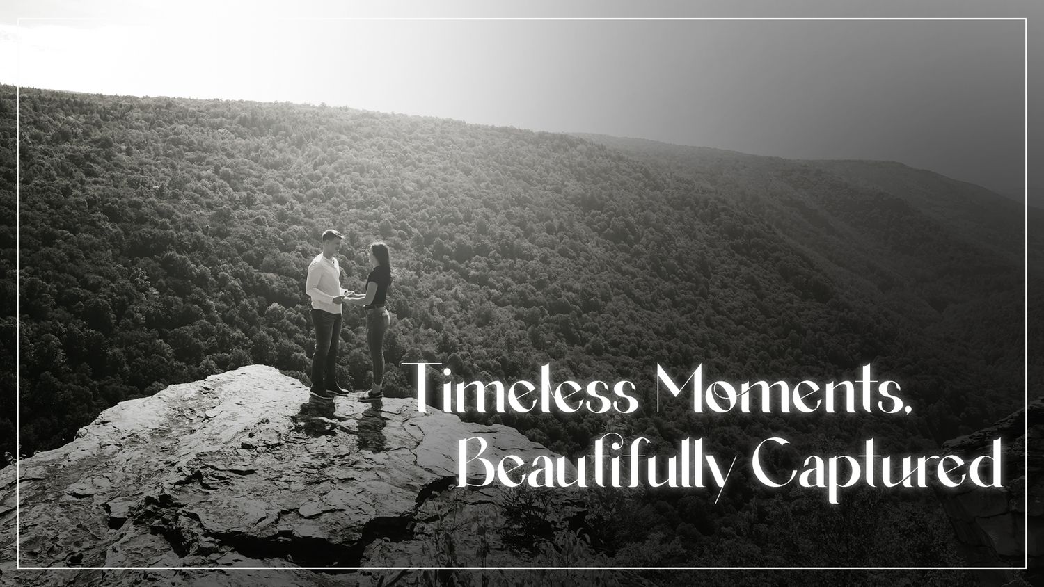 Black and white photo of two silhouettes standing on a cliff edge overlooking mountains with overlaid text about timeless moments.