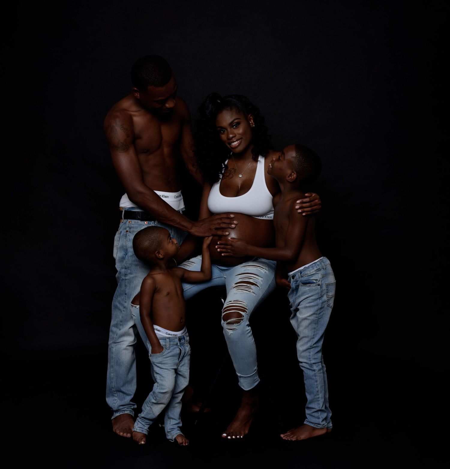 Group photo showing casual denim style against black background.