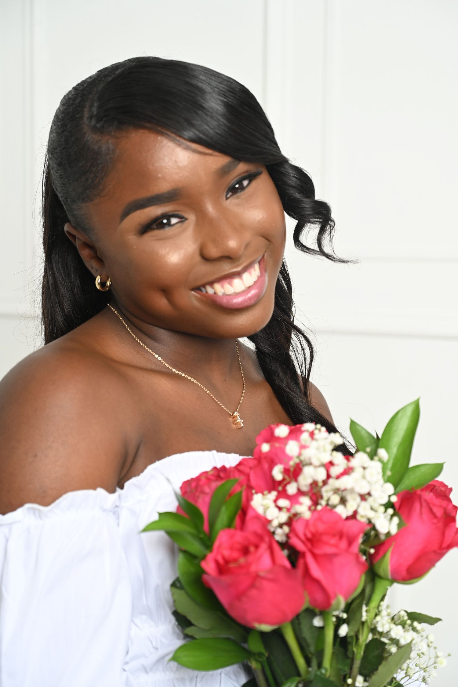 Professional portrait with pink roses and white baby's breath bouquet against a bright white background in Saint Petersburg Florida.