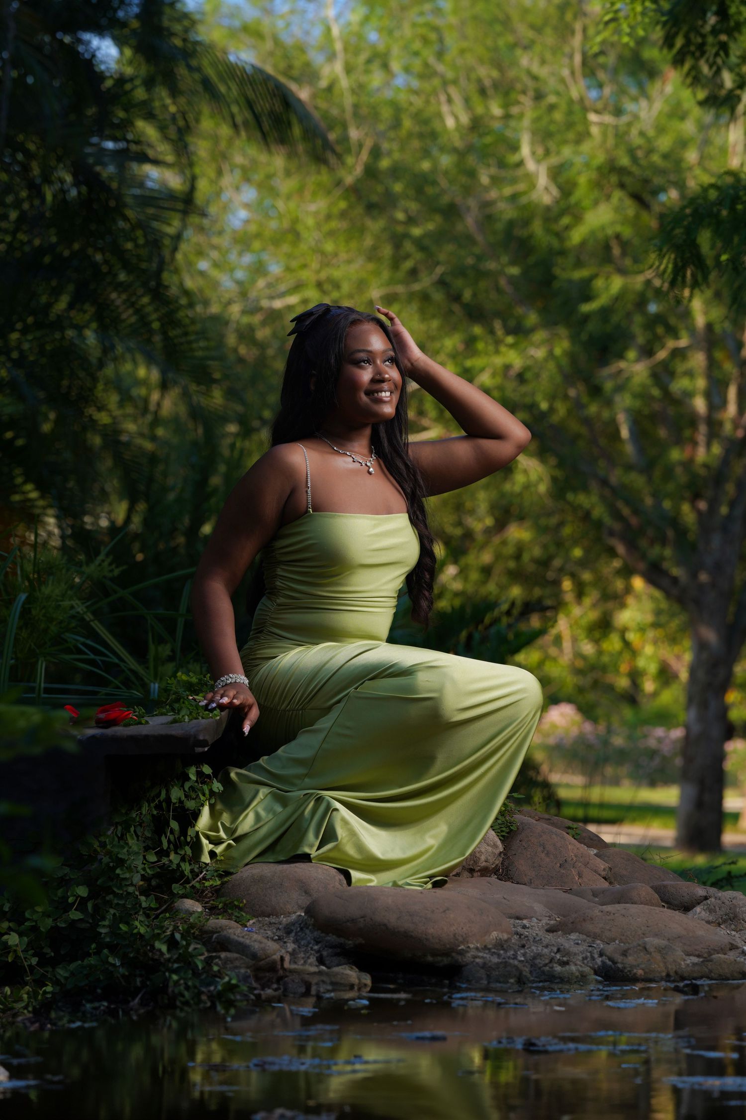 Nature portrait in lime green dress posed by stream with lush greenery in Saint Petersburg Florida.