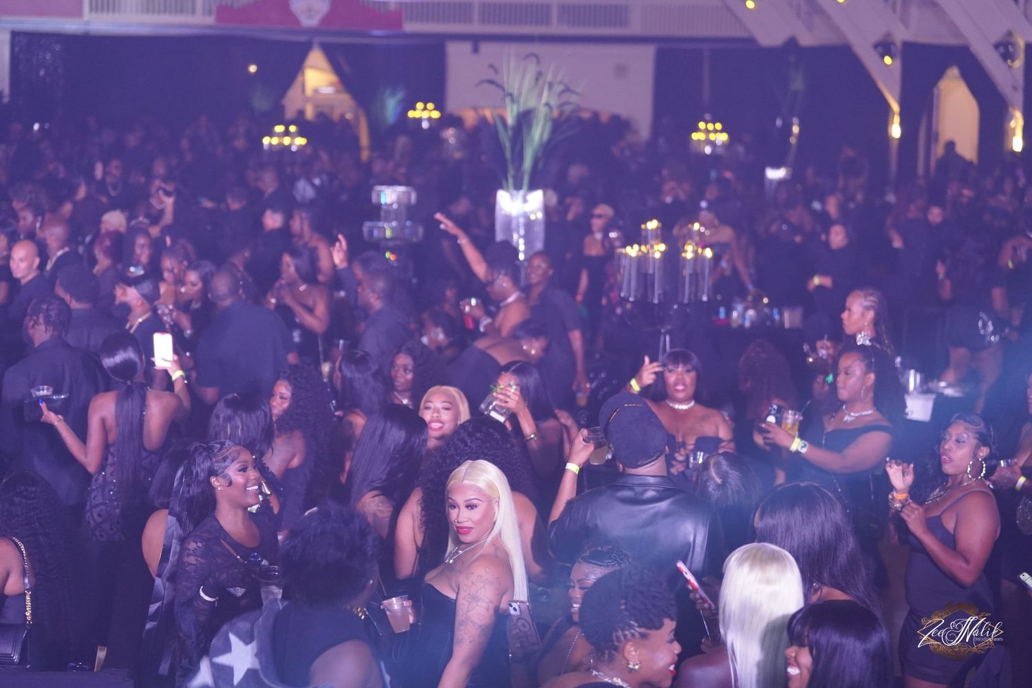 Crowded nightclub scene with purple lighting and packed dance floor in Tampa Florida.