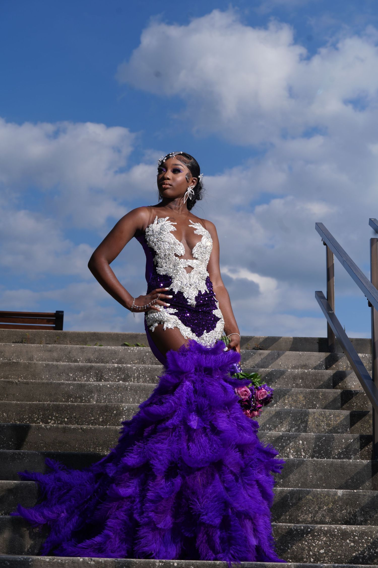 Dramatic purple and white gown photographed on concrete steps under blue sky in Saint Petersburg Florida.