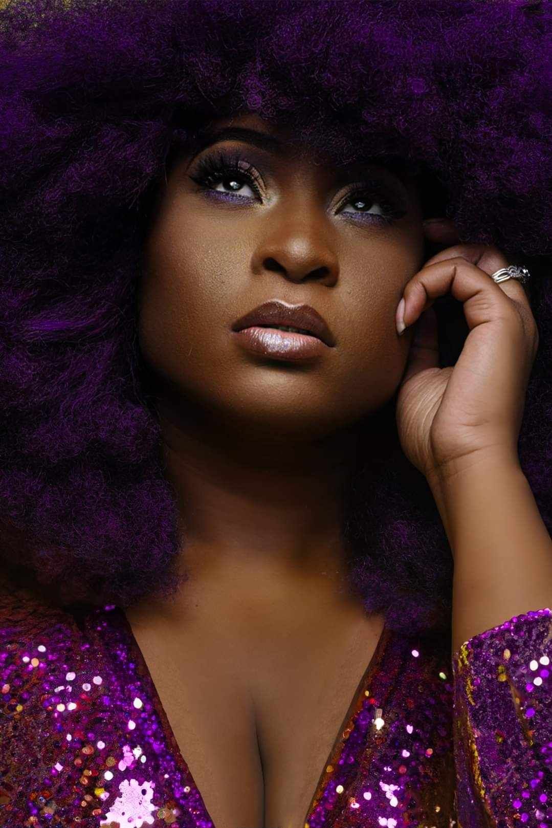 Tampa Florida Glamorous portrait in purple sparkly dress against dark dramatic background.