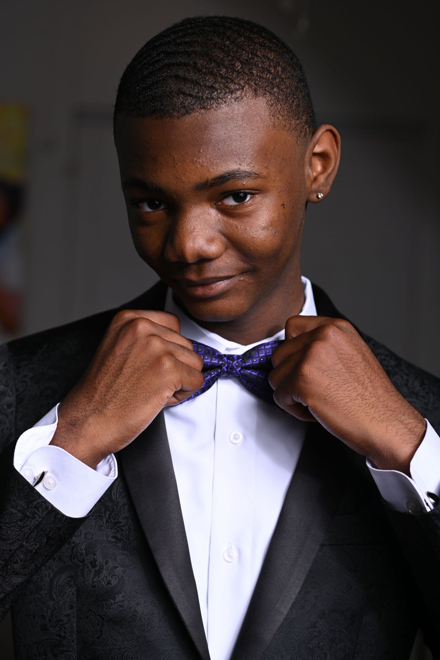 Formal portrait series featuring black tuxedo and purple bowtie details in Saint Petersburg Florida.