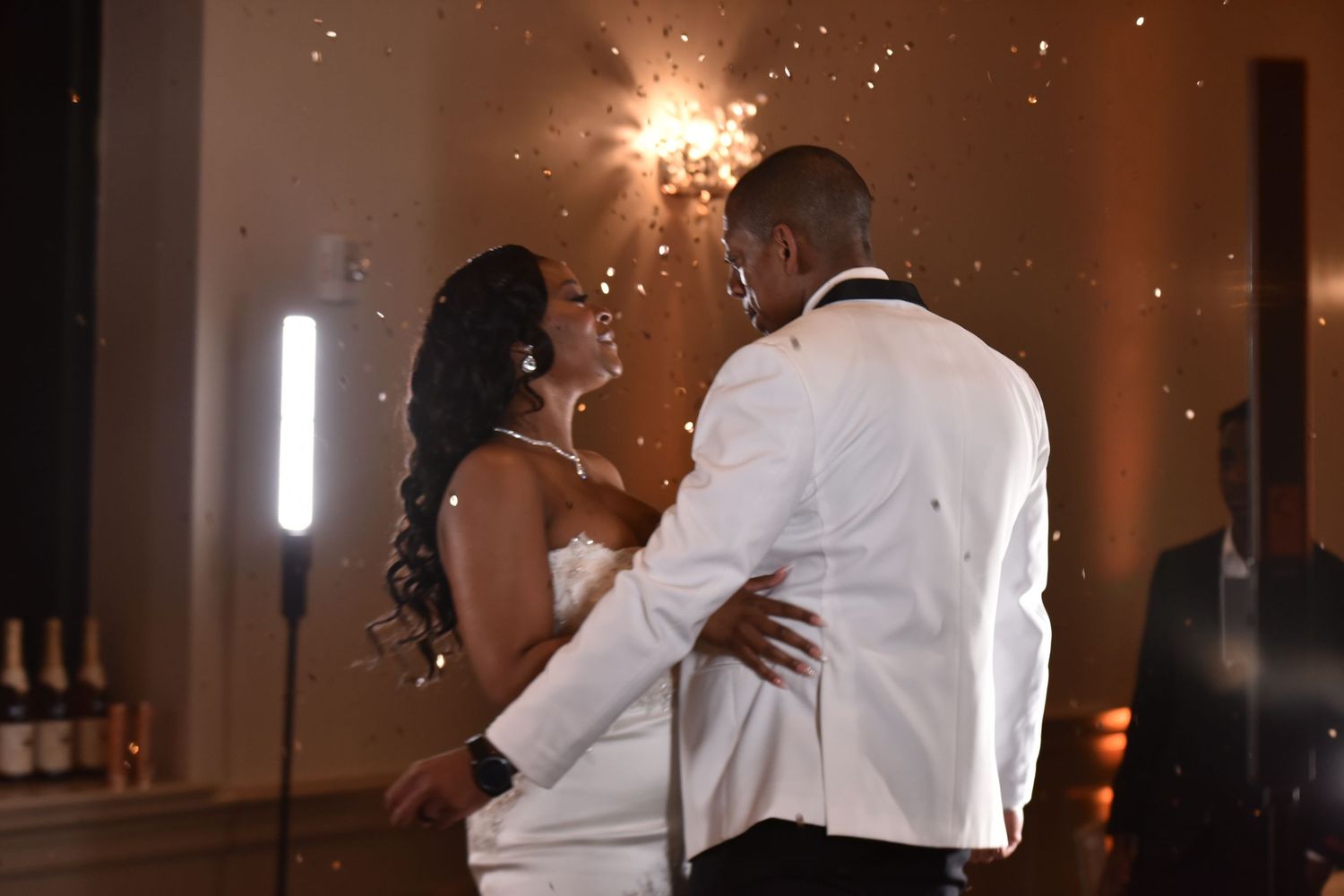 Wedding couple's first dance with sparklers creating magical lighting effects.