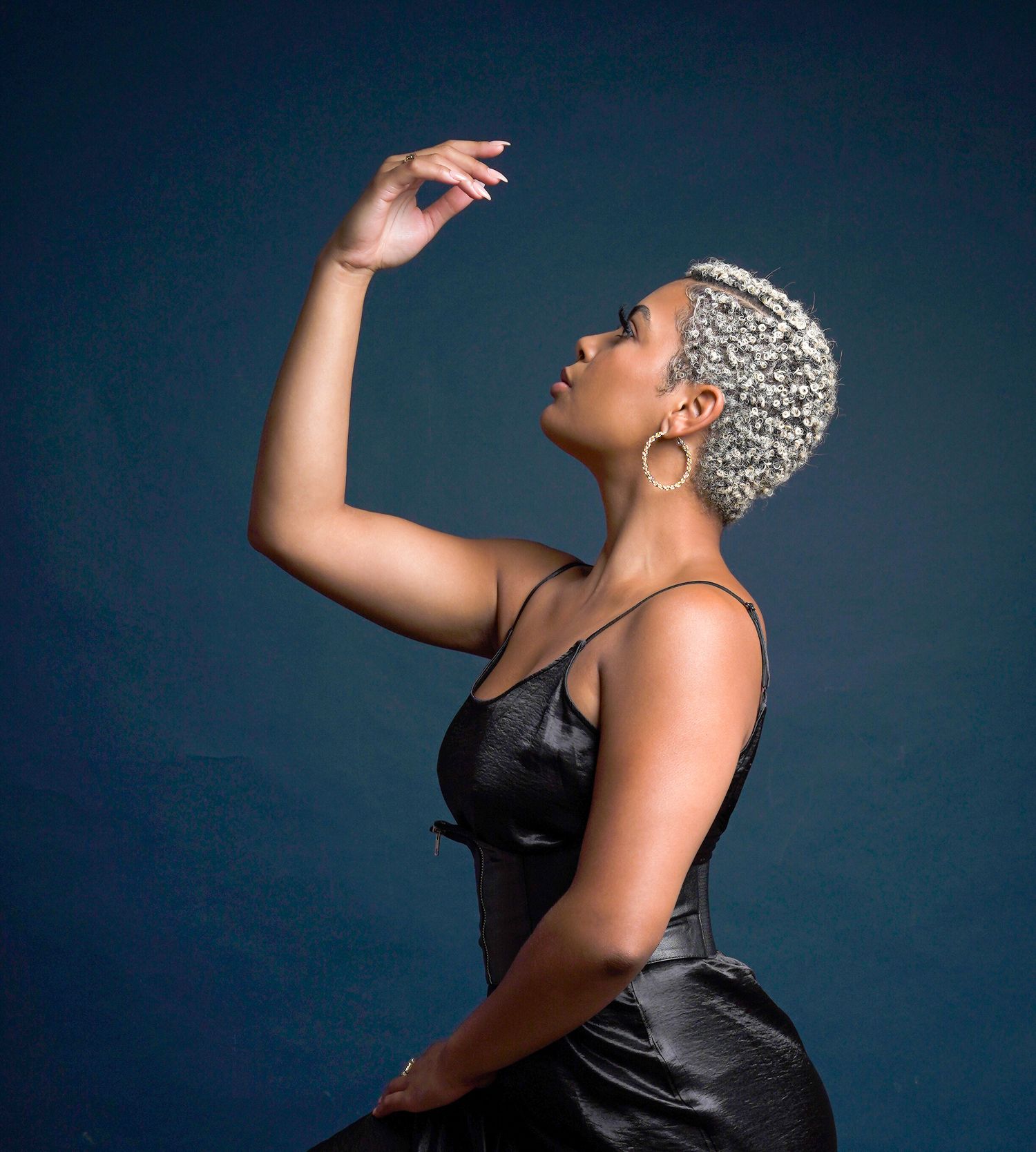 Artistic portrait series in black satin against dark blue backdrop showing dramatic dance-inspired poses in Saint Petersburg Florida.