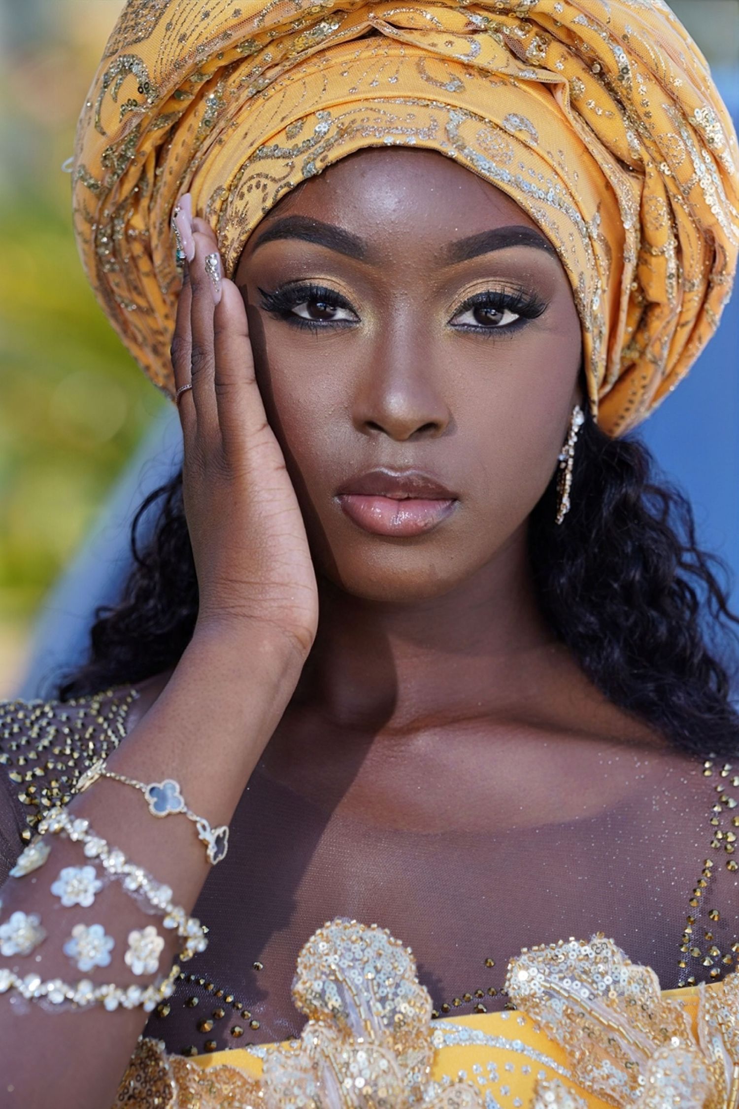 Traditional African prom attire featuring gold headwrap and sparkling jewelry details in Saint Petersburg Florida.