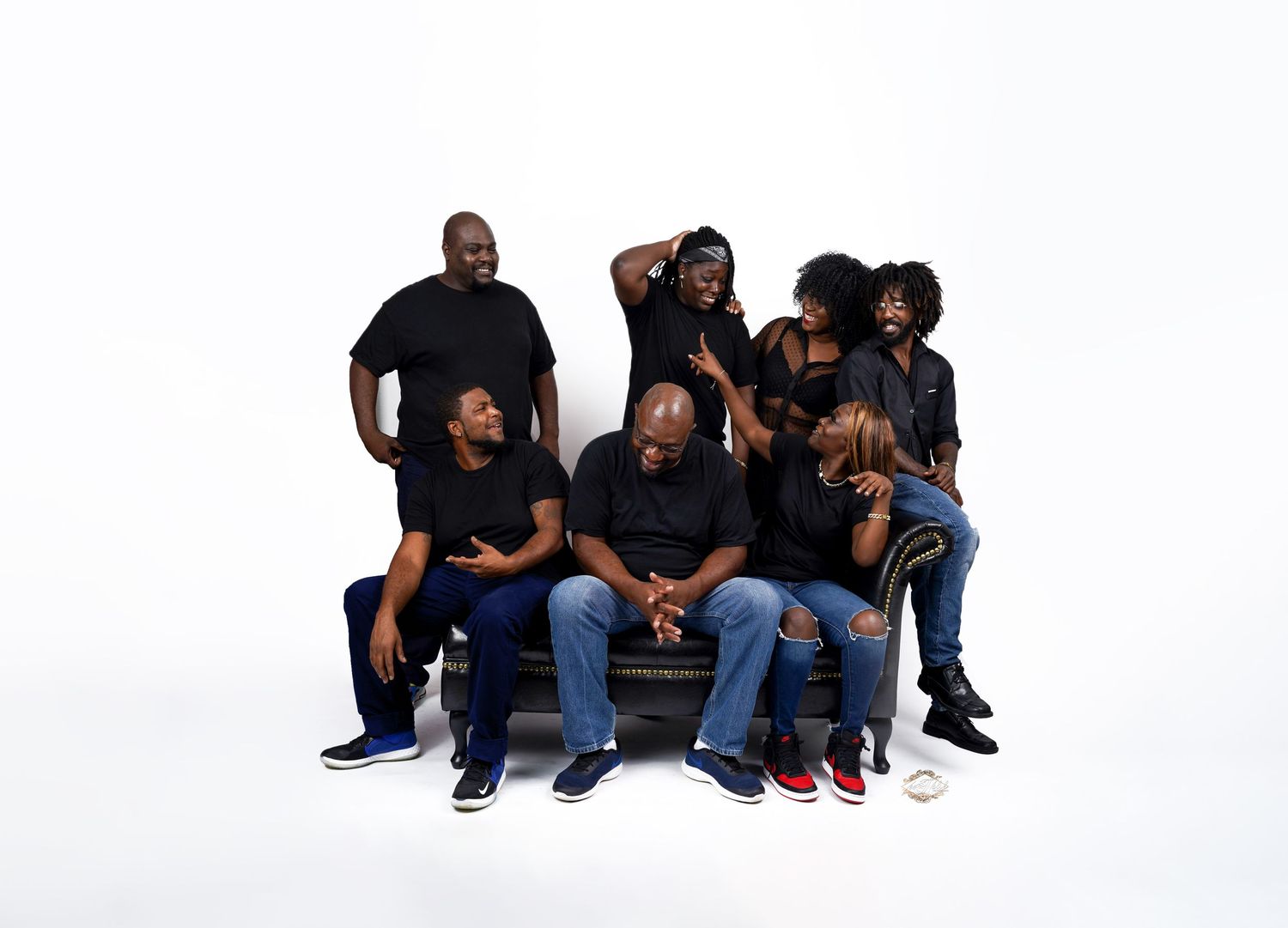 Group portrait of family members in coordinated casual outfits against white background in Saint Petersburg Florida.